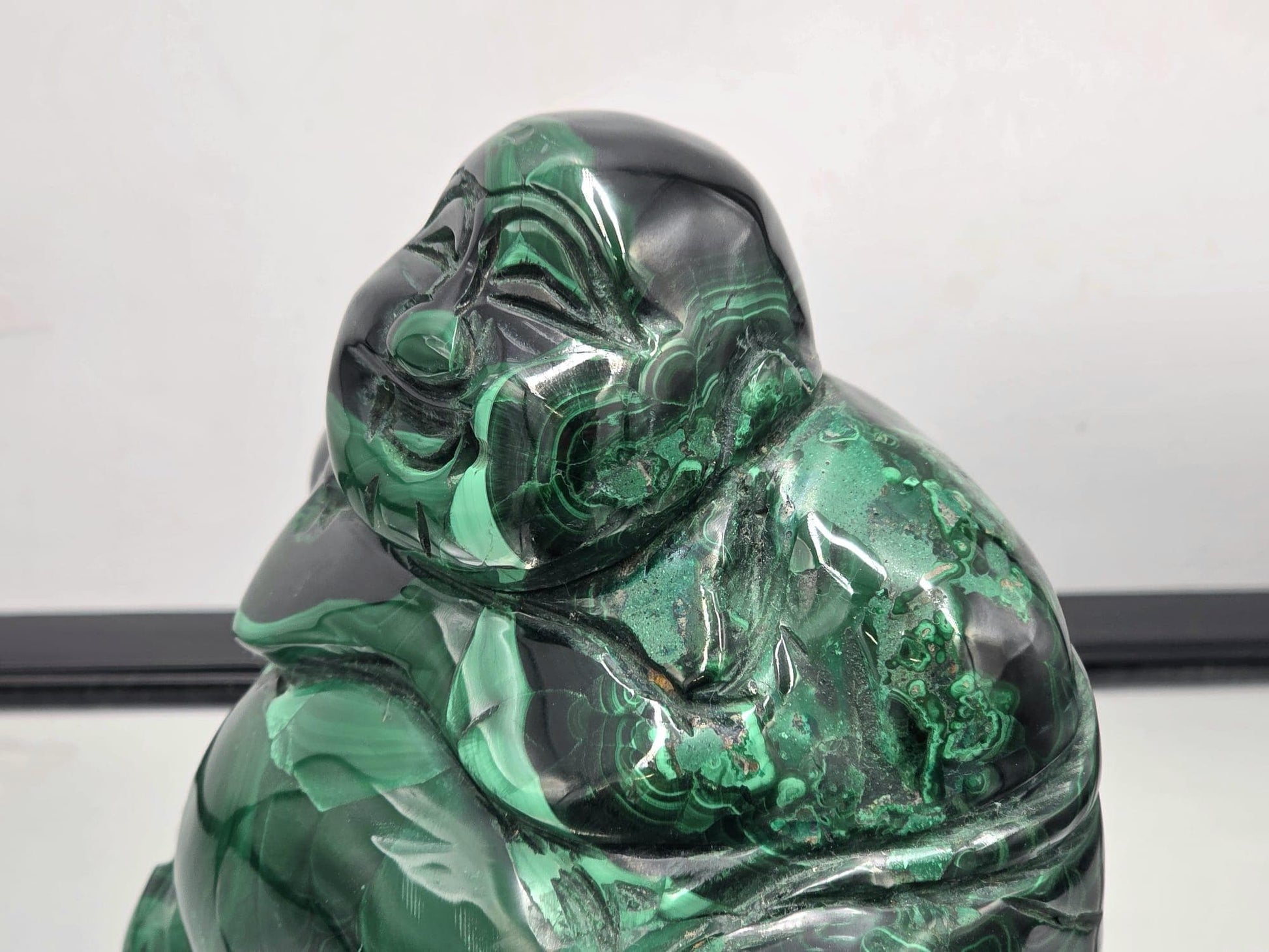Hand-carved Malachite Buddha figure made from genuine malachite crystal, radiating grounding and heart-healing energy.