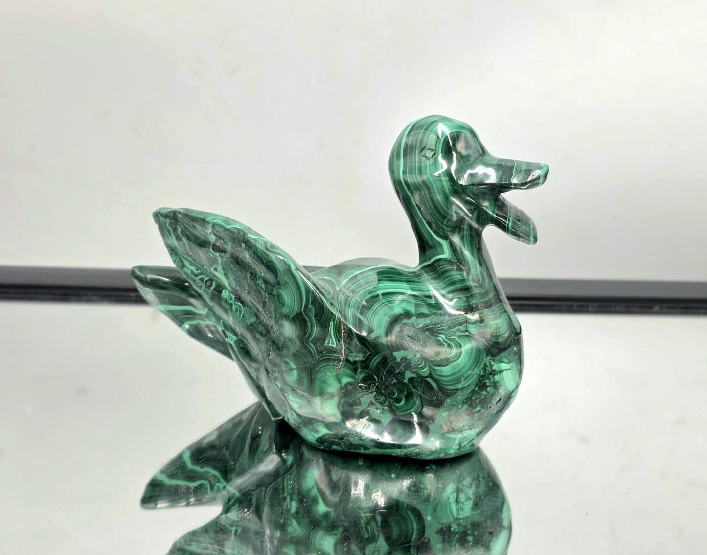 Hand-carved malachite duck displayed on tabletop