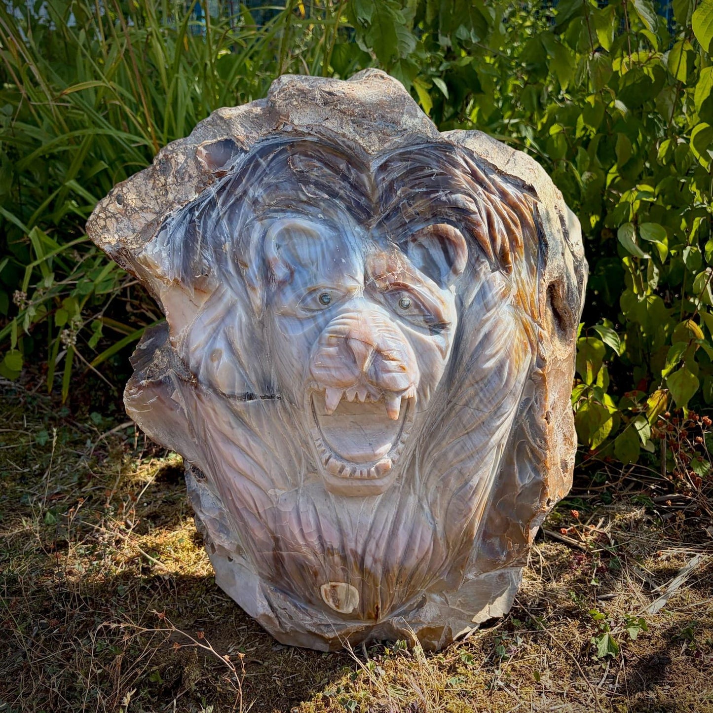 Hand-carved Violet Agate lion displaying beautiful natural banding and polished finish.