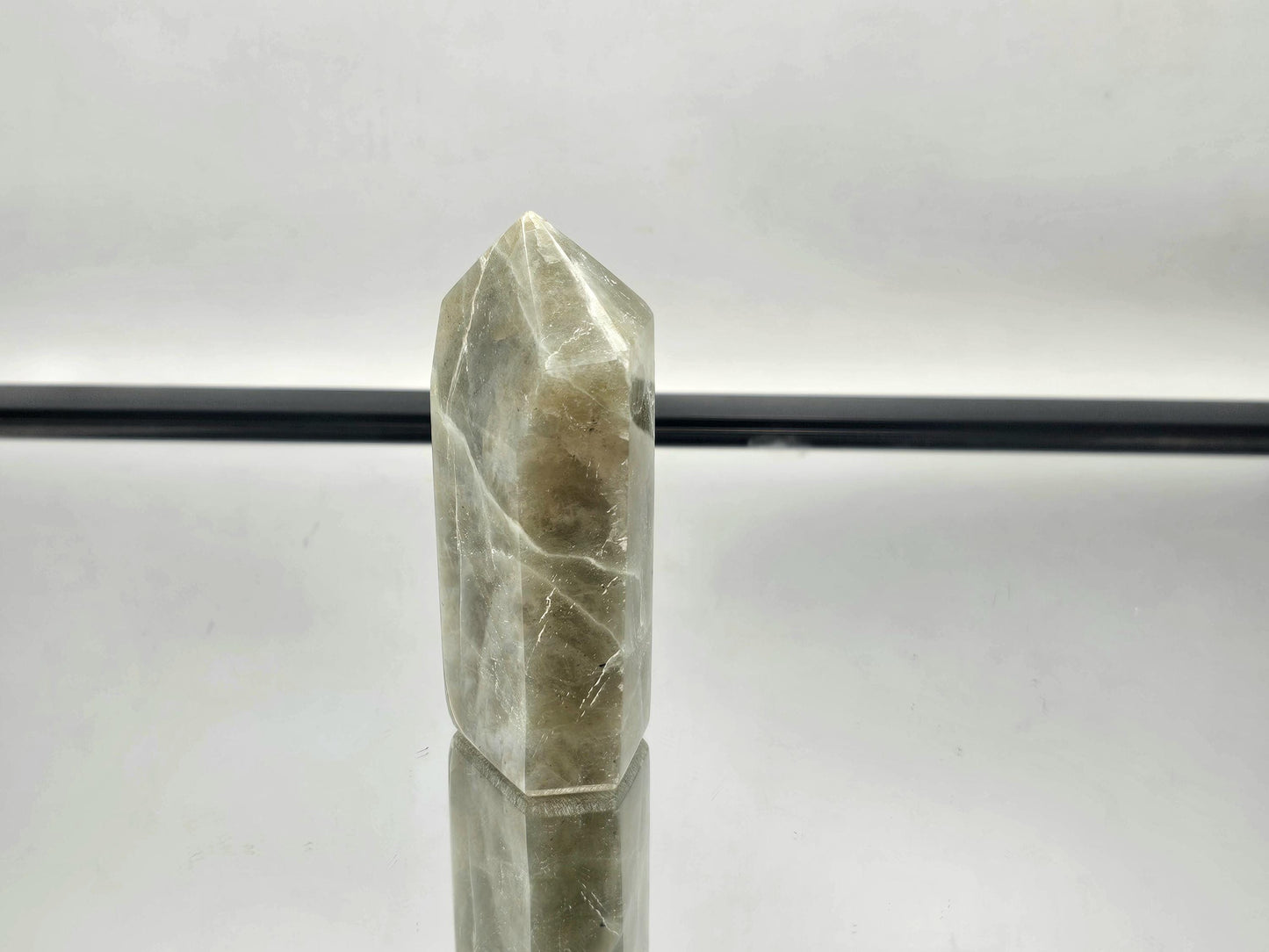 Green Moonstone crystal with tower garnet inclusions, part of our exclusive collection.