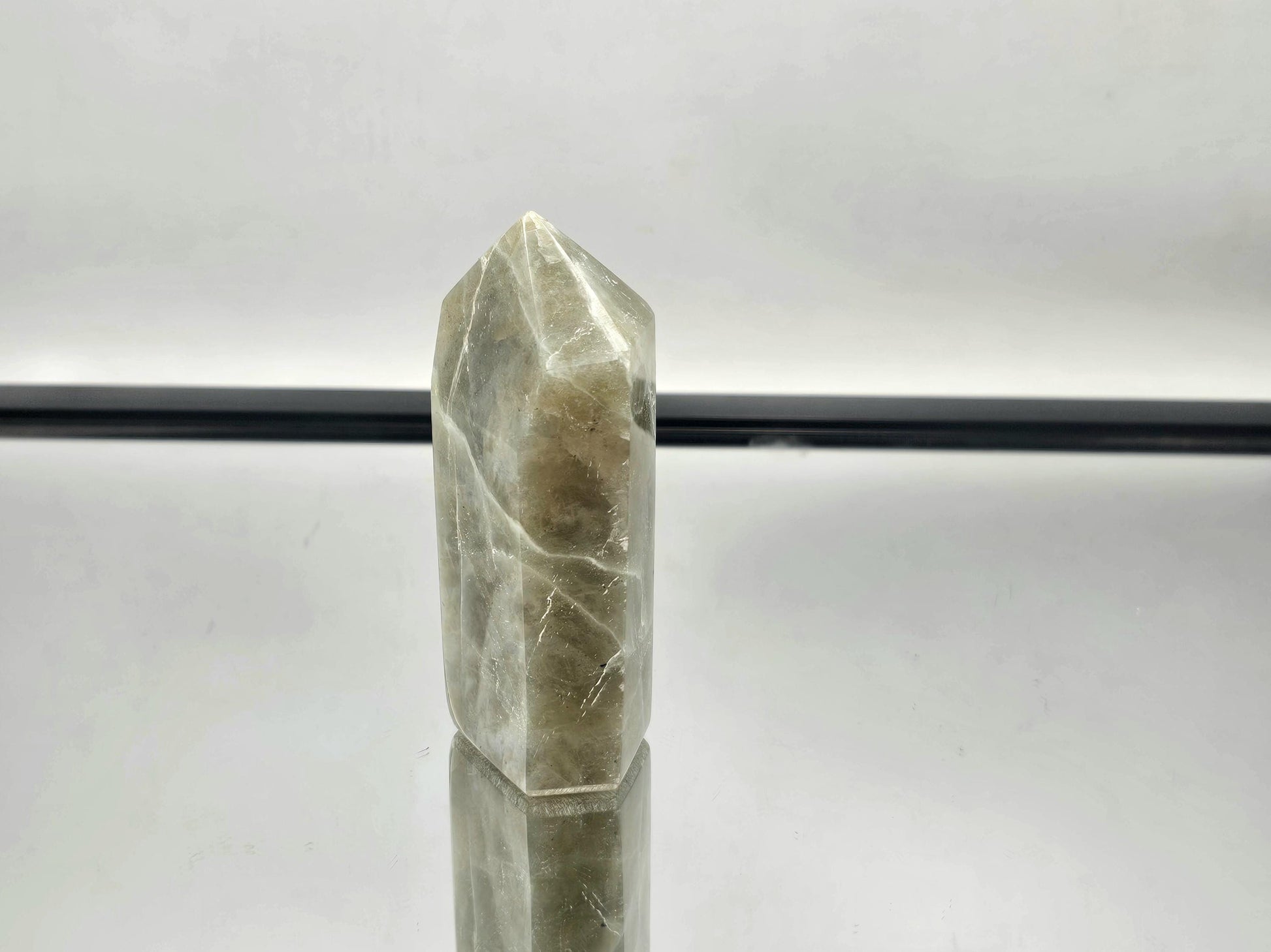 Green Moonstone crystal with tower garnet inclusions, part of our exclusive collection.