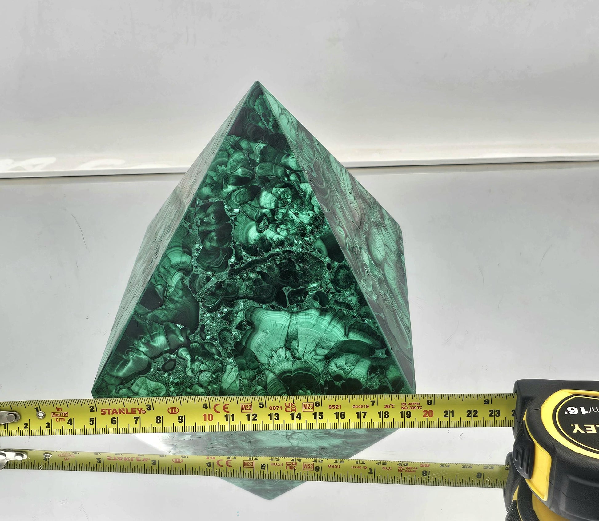 medium Malachite pyramid for upscale interior design and crystal enthusiasts.