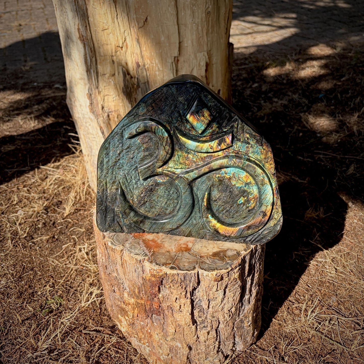 Angled display highlighting the exceptional rainbow flash across the carved Labradorite freeform.