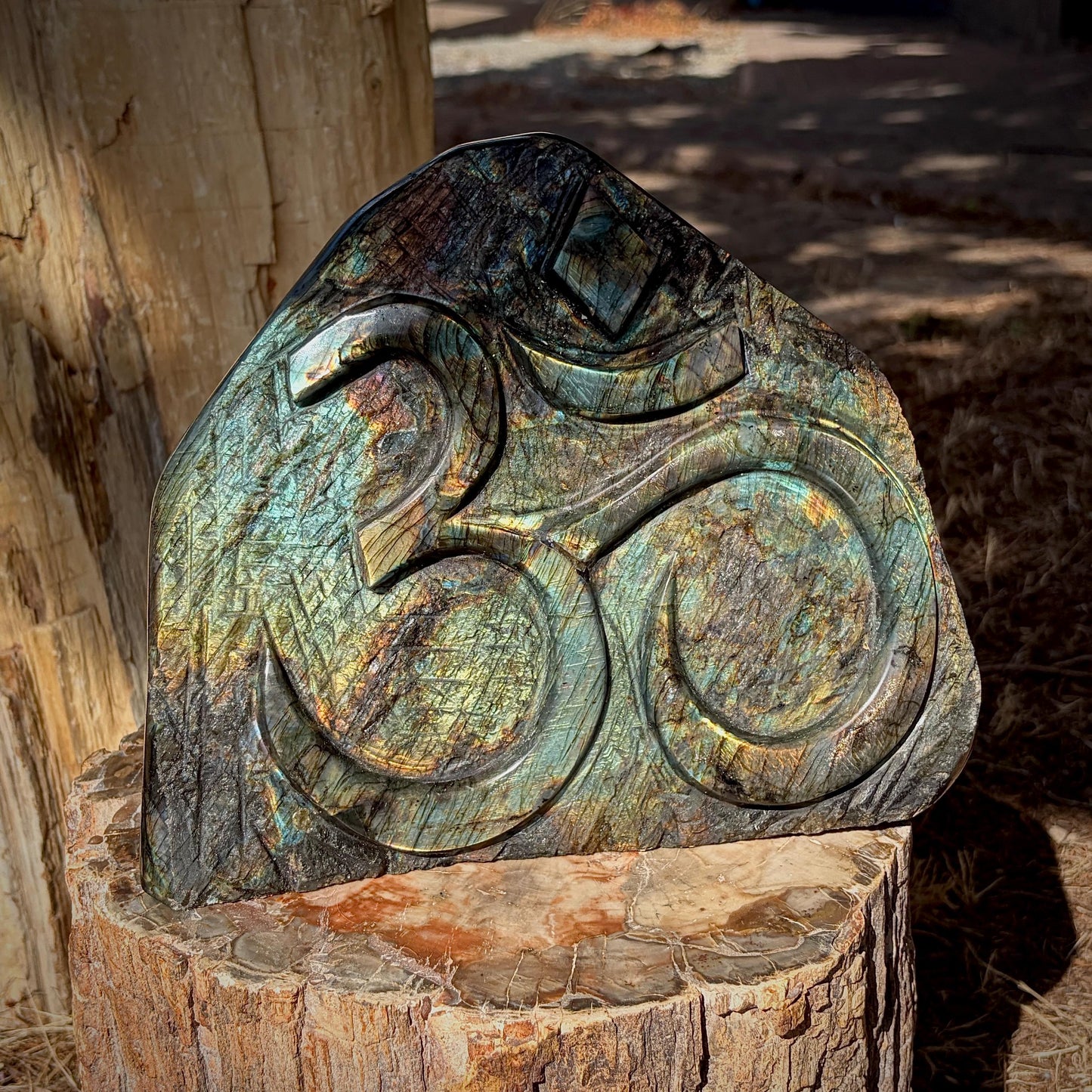 Side profile of polished Labradorite Sacred Om freeform with colourful natural labradorescence.