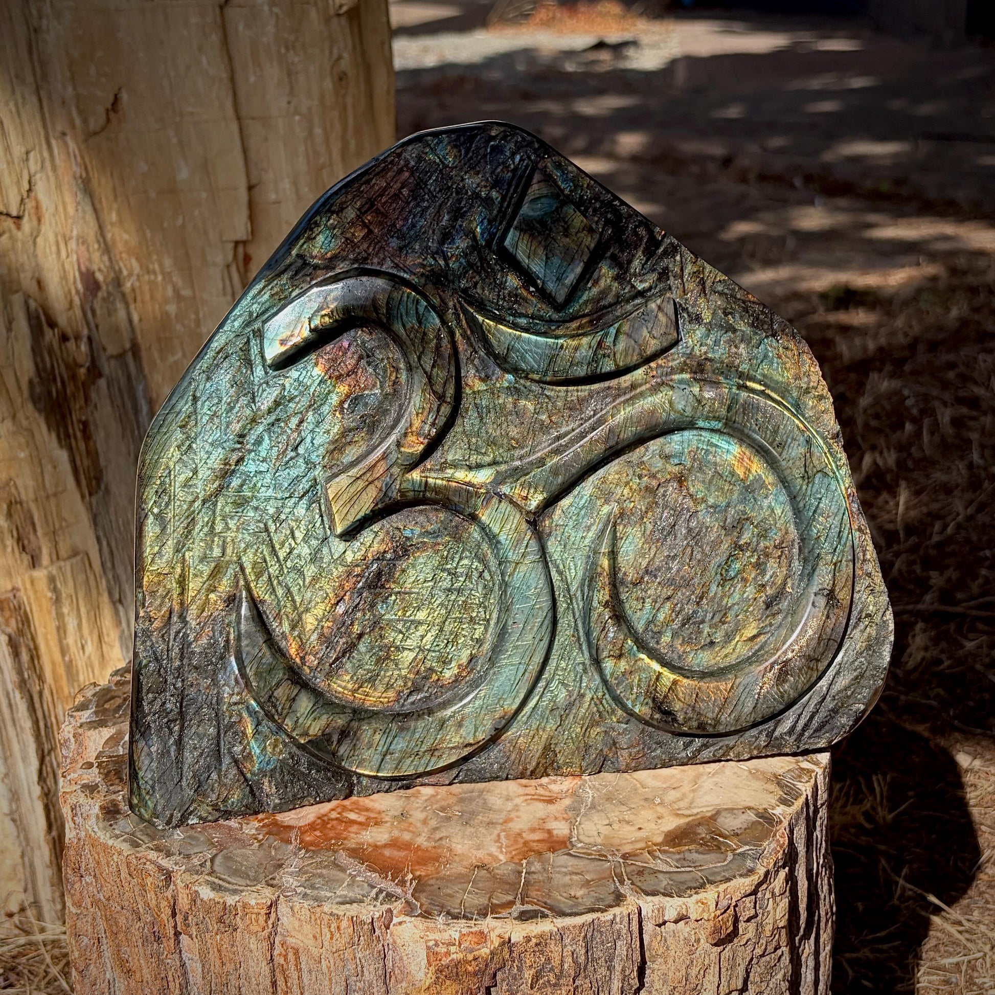 Side profile of polished Labradorite Sacred Om freeform with colourful natural labradorescence.