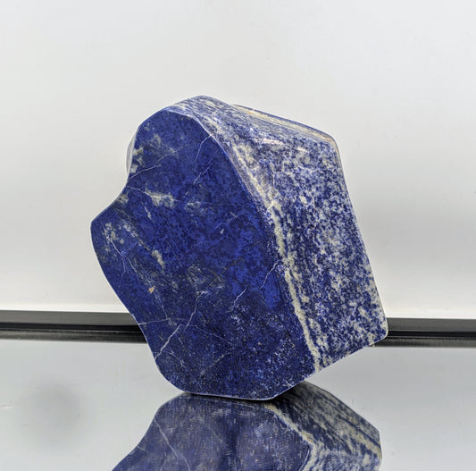 Freeform gemstone of Lapis Lazuli polished to reveal natural beauty.