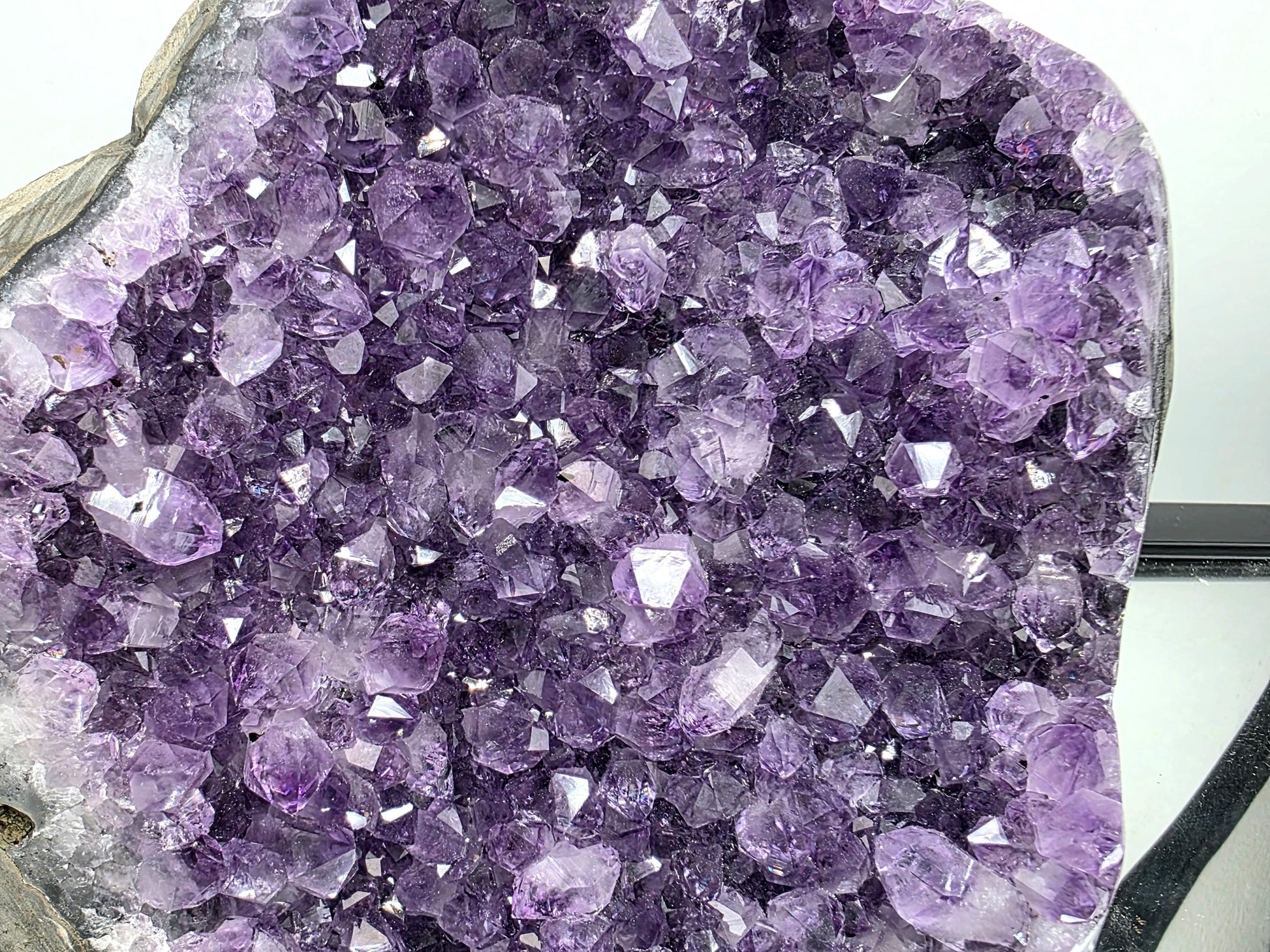 Large Uruguayan amethyst geode styled as a home décor display piece with rich purple quartz crystals.