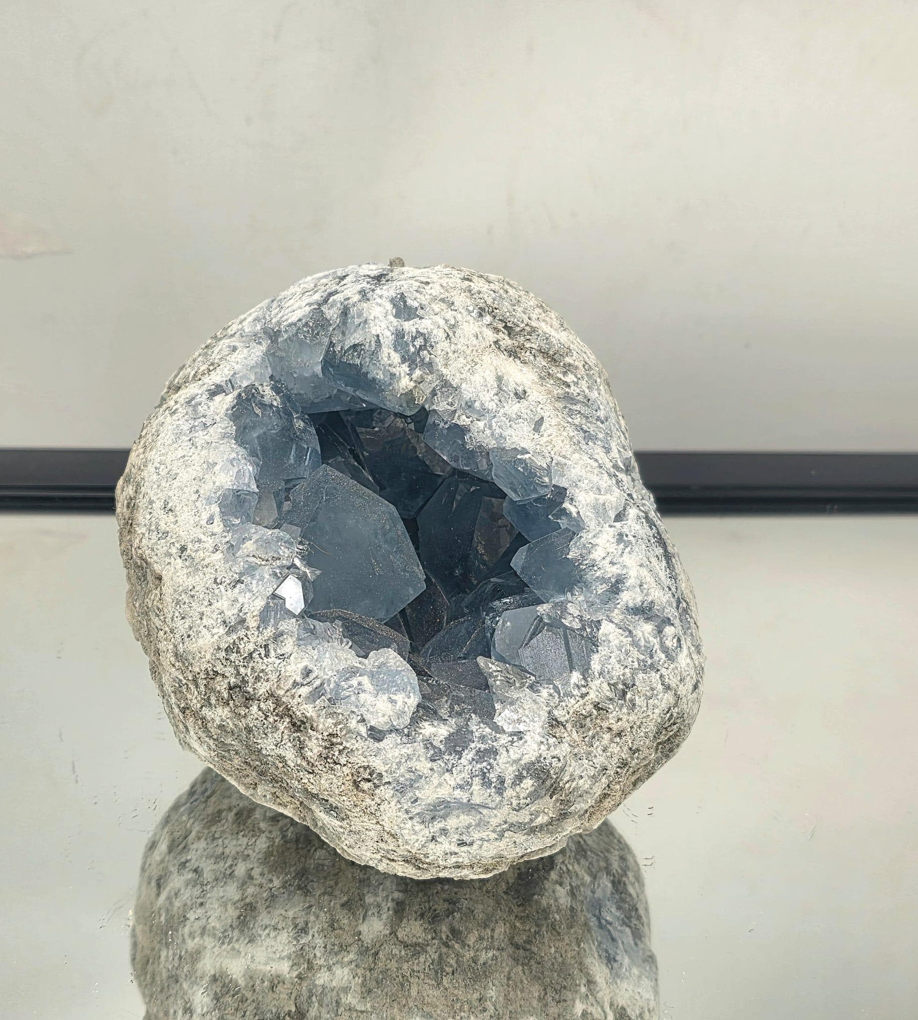 Large celestite crystal cluster with translucent blue points