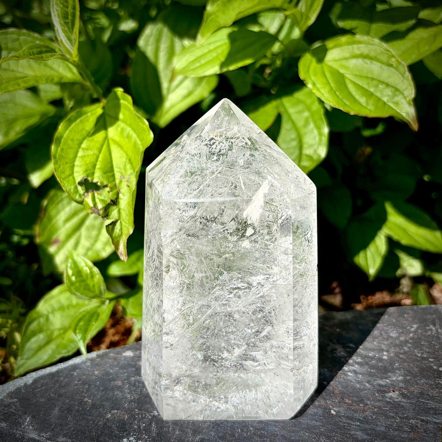Large clear quartz crystal tower from Madagascar with polished prism shape for natural home decor.