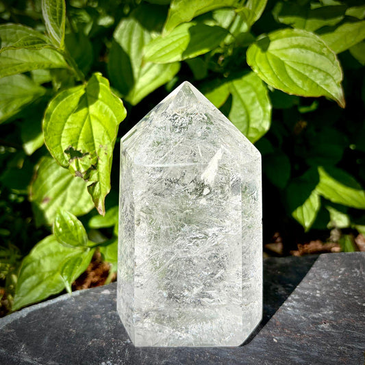 Large clear quartz crystal tower from Madagascar with polished prism shape for natural home decor.
