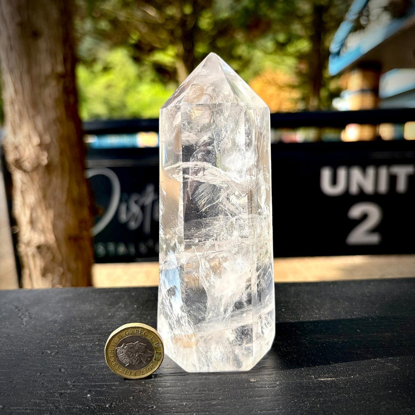 Large clear quartz table decor piece with polished finish and natural mineral textures.