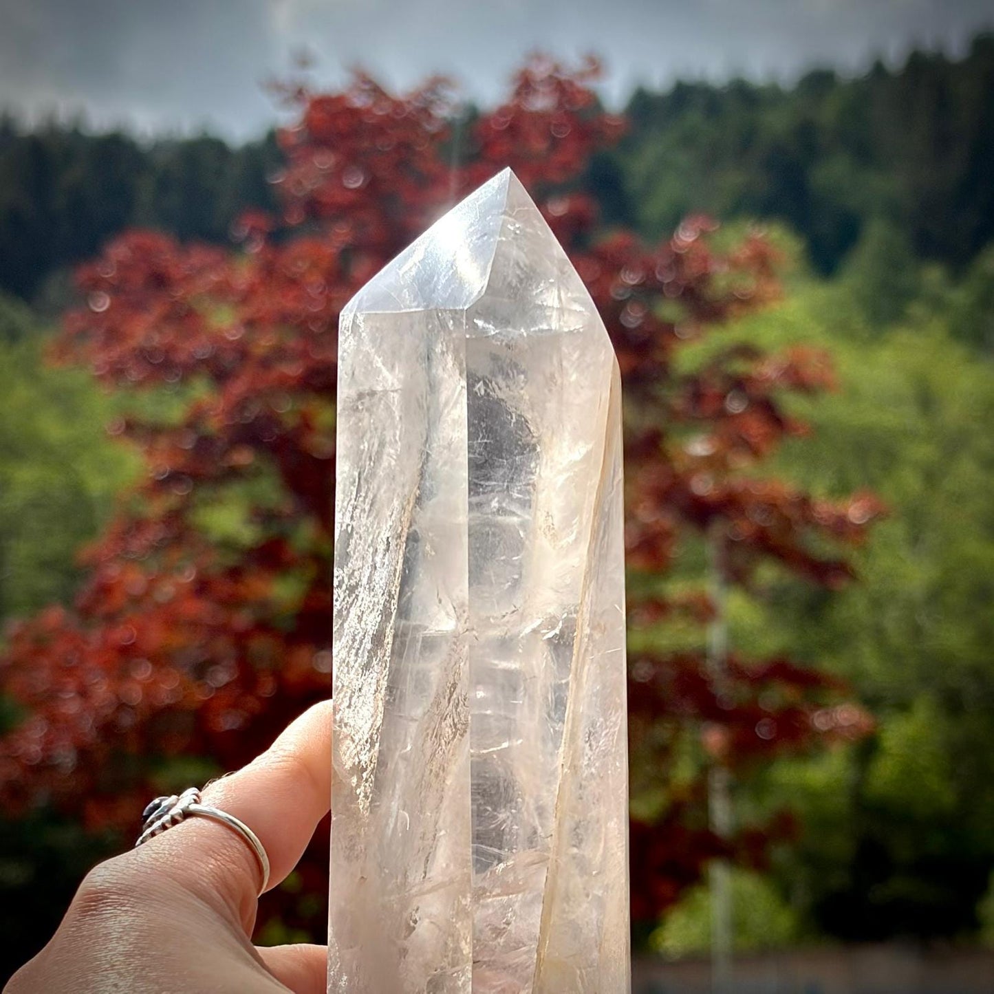 Large crystal tower in clear quartz, polished for decorative display and natural home styling.