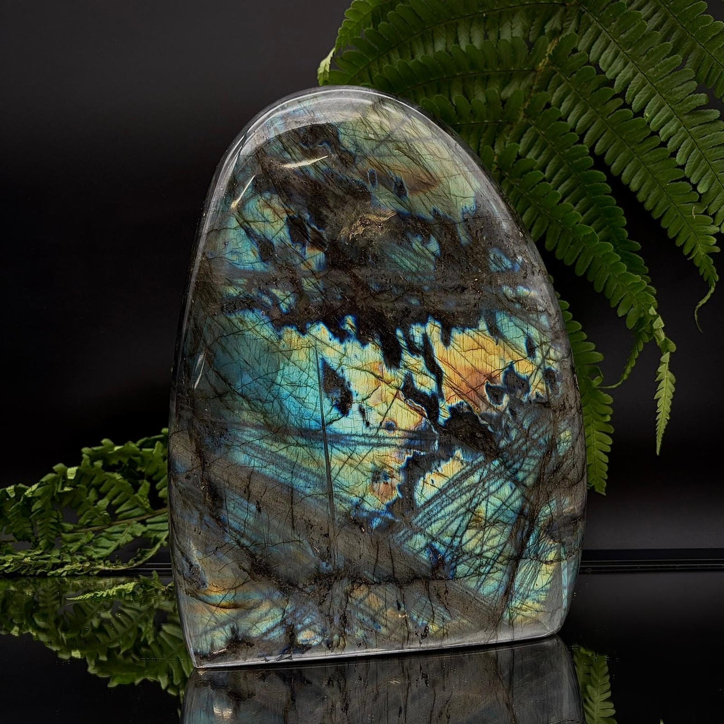 Large labradorite crystal display piece, carved and polished to highlight natural flash and form.