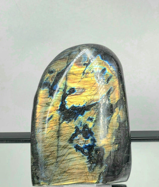 Large Labradorite crystal freeform from Madagascar with vivid blue and green flash.