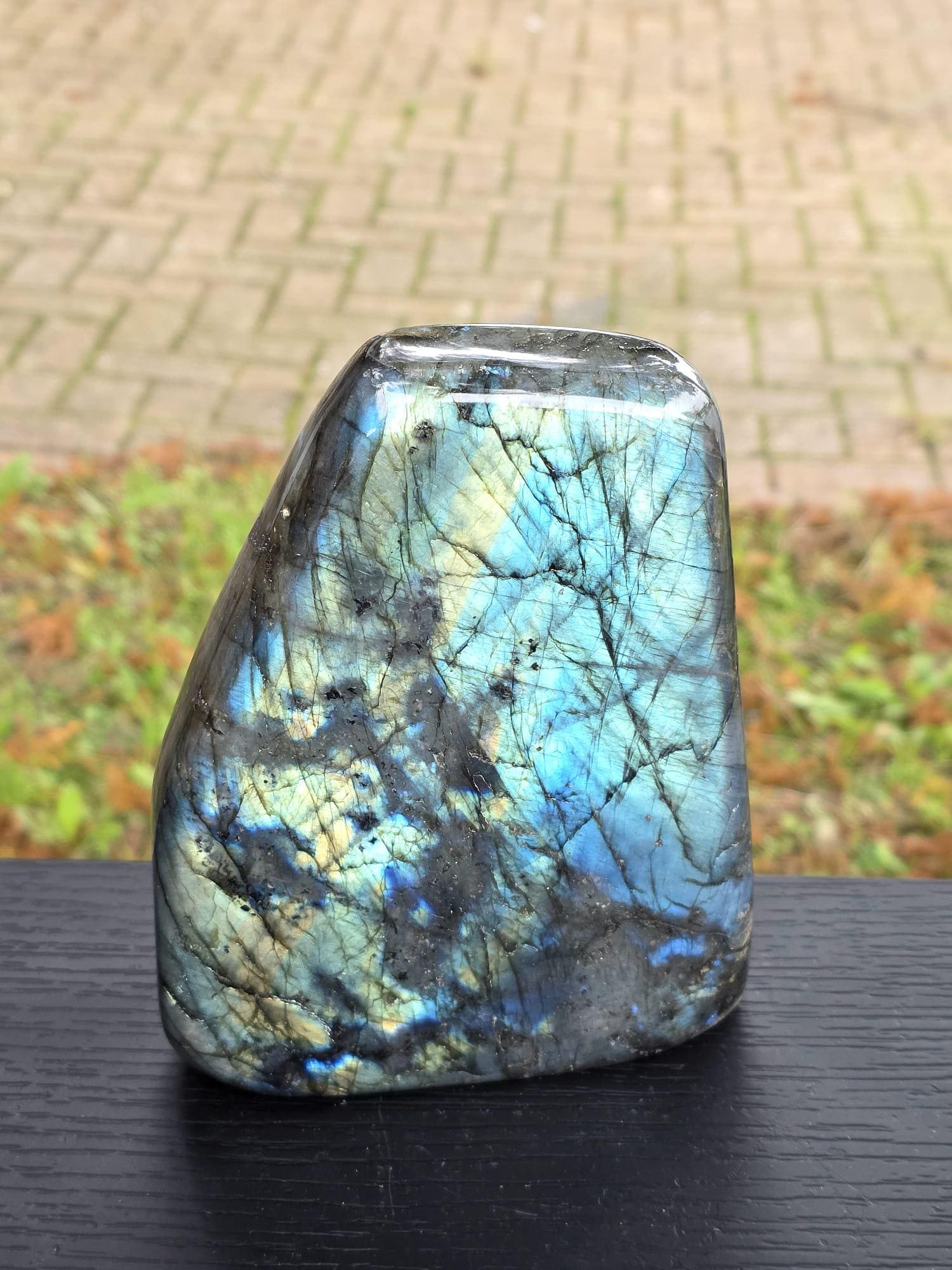 Front view of large labradorite crystal showing strong blue flash and polished surface.