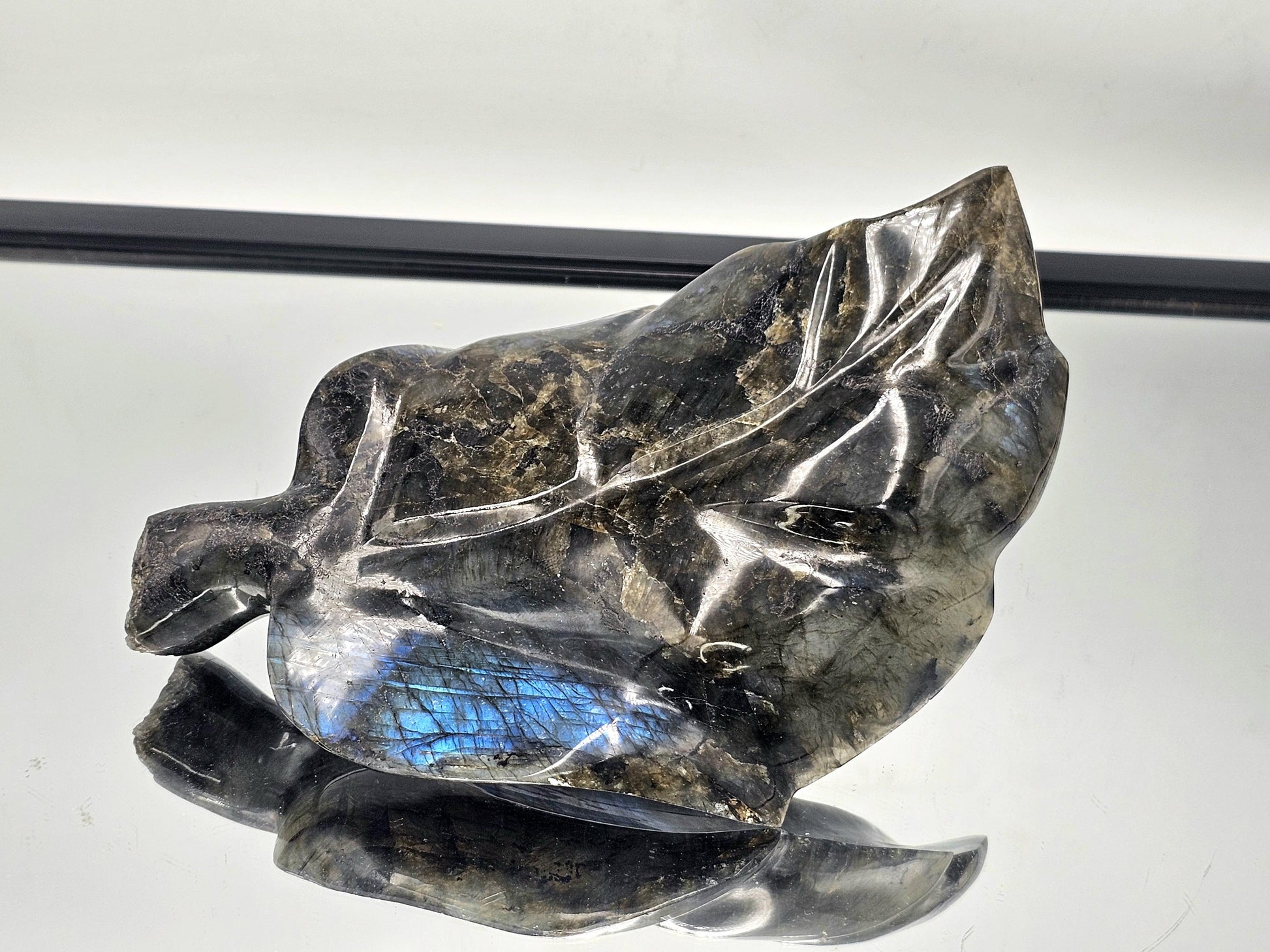 Large Labradorite leaf carving with iridescent flashes of color, perfect for a luxury crystal collection.
