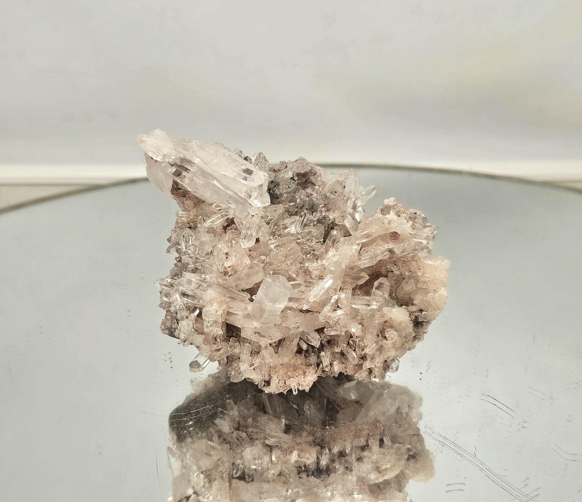arge Lemurian quartz crystal displayed on a stand