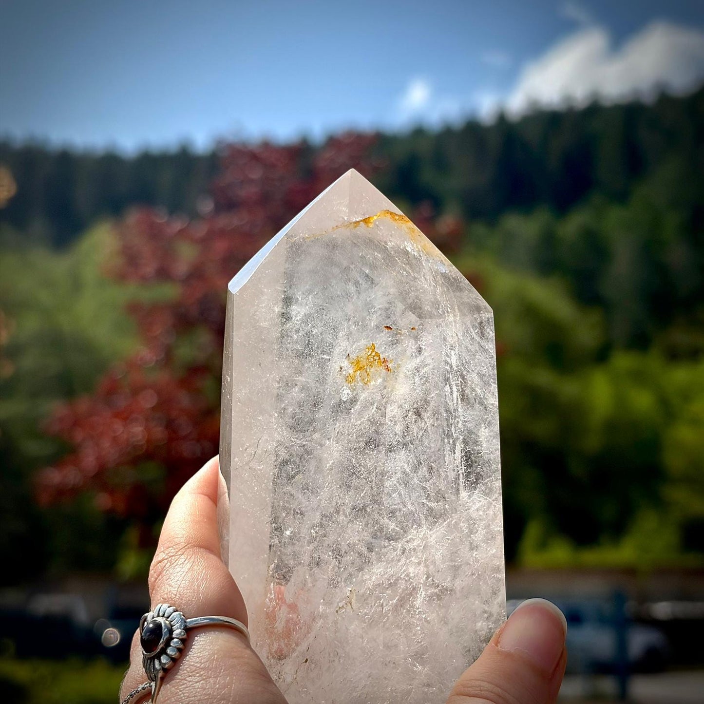 Large natural quartz crystal tower with polished faces and elegant decorative appeal.