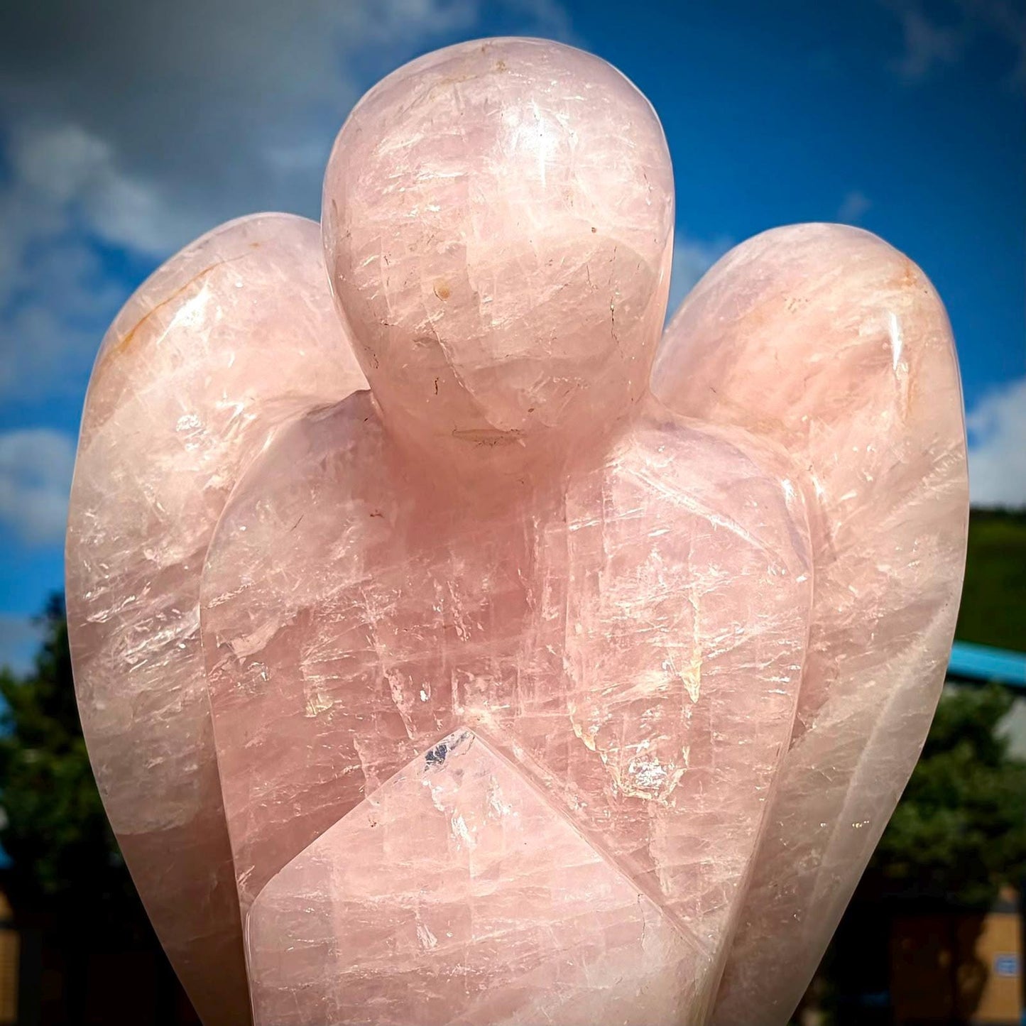 Large polished pink Quartz angel carving with detailed wings and natural internal veining.
