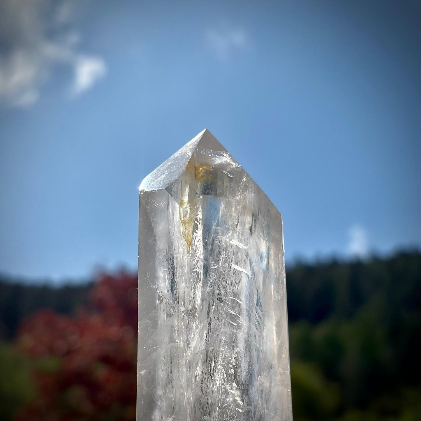 Large polished clear quartz prism with natural rainbow, veiling and decorative display presence.