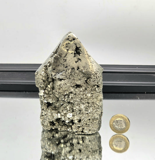 Golden pyrite tower with gleaming polished top section.