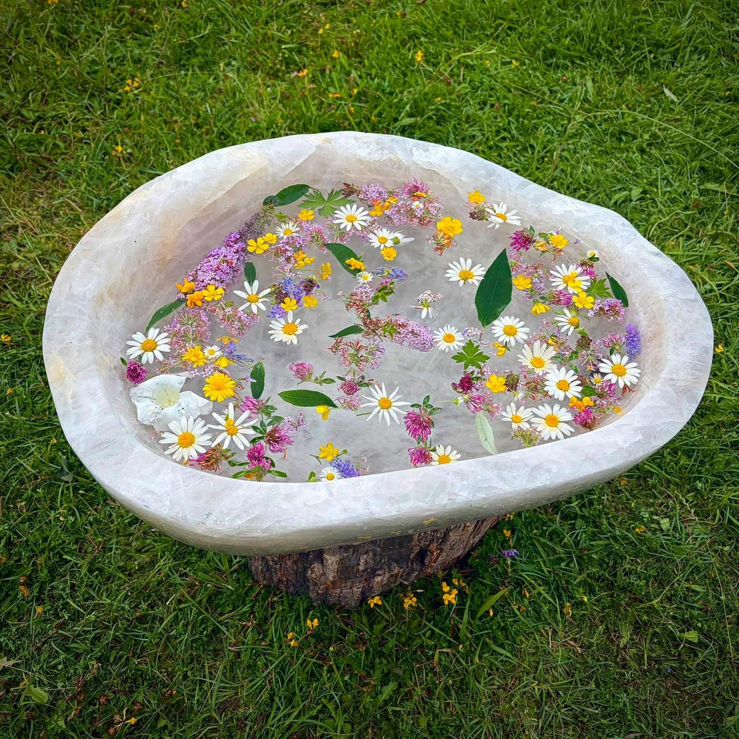 Top view of a large polished Quartz bowl with natural veining and curved form.