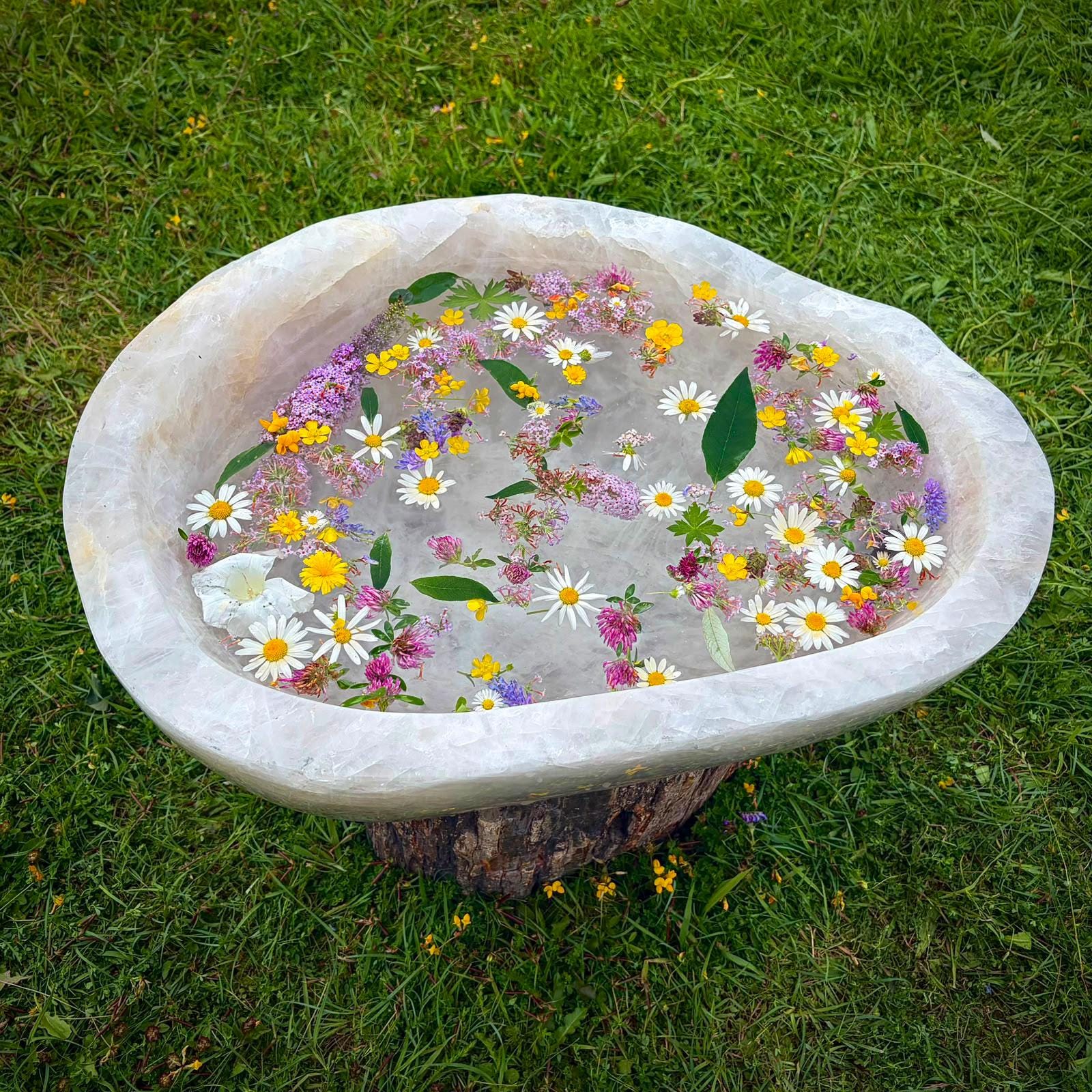Top view of a large polished Quartz bowl with natural veining and curved form.
