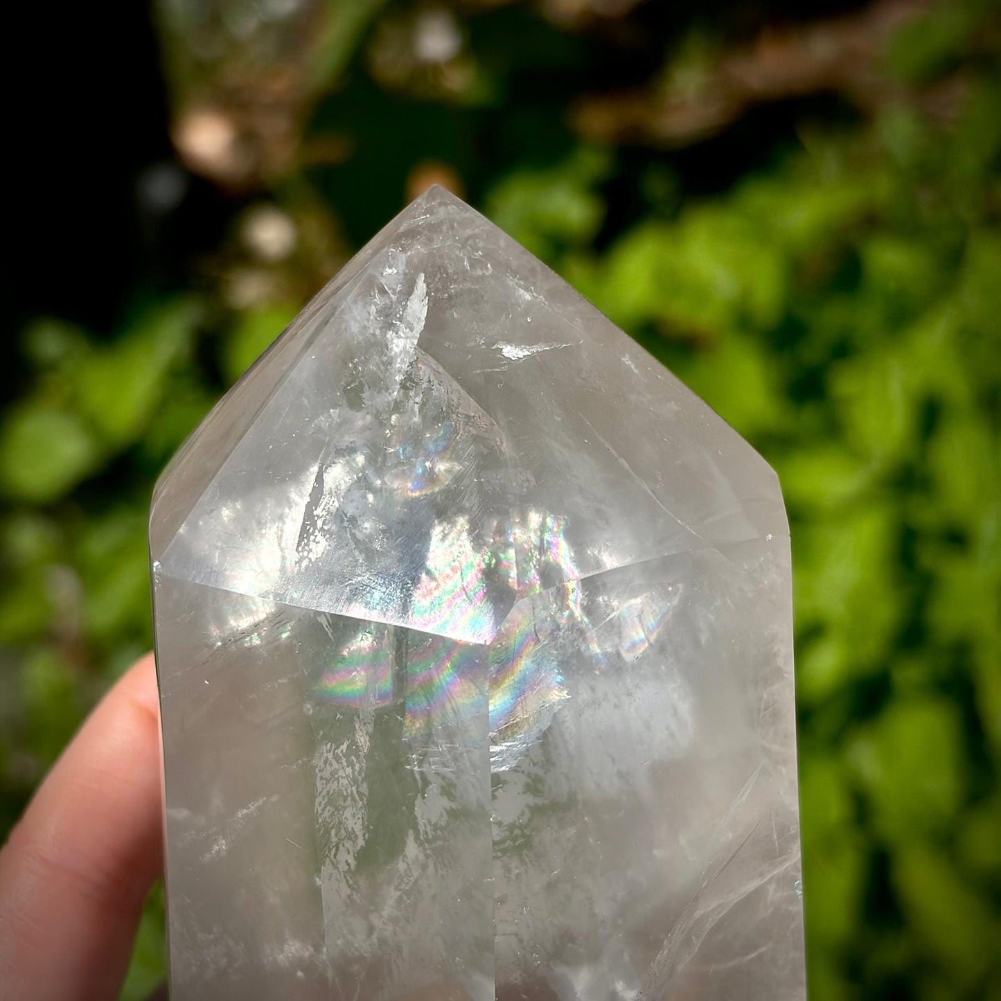 Large polished quartz crystal point from Madagascar with refined shape and natural mineral detail.