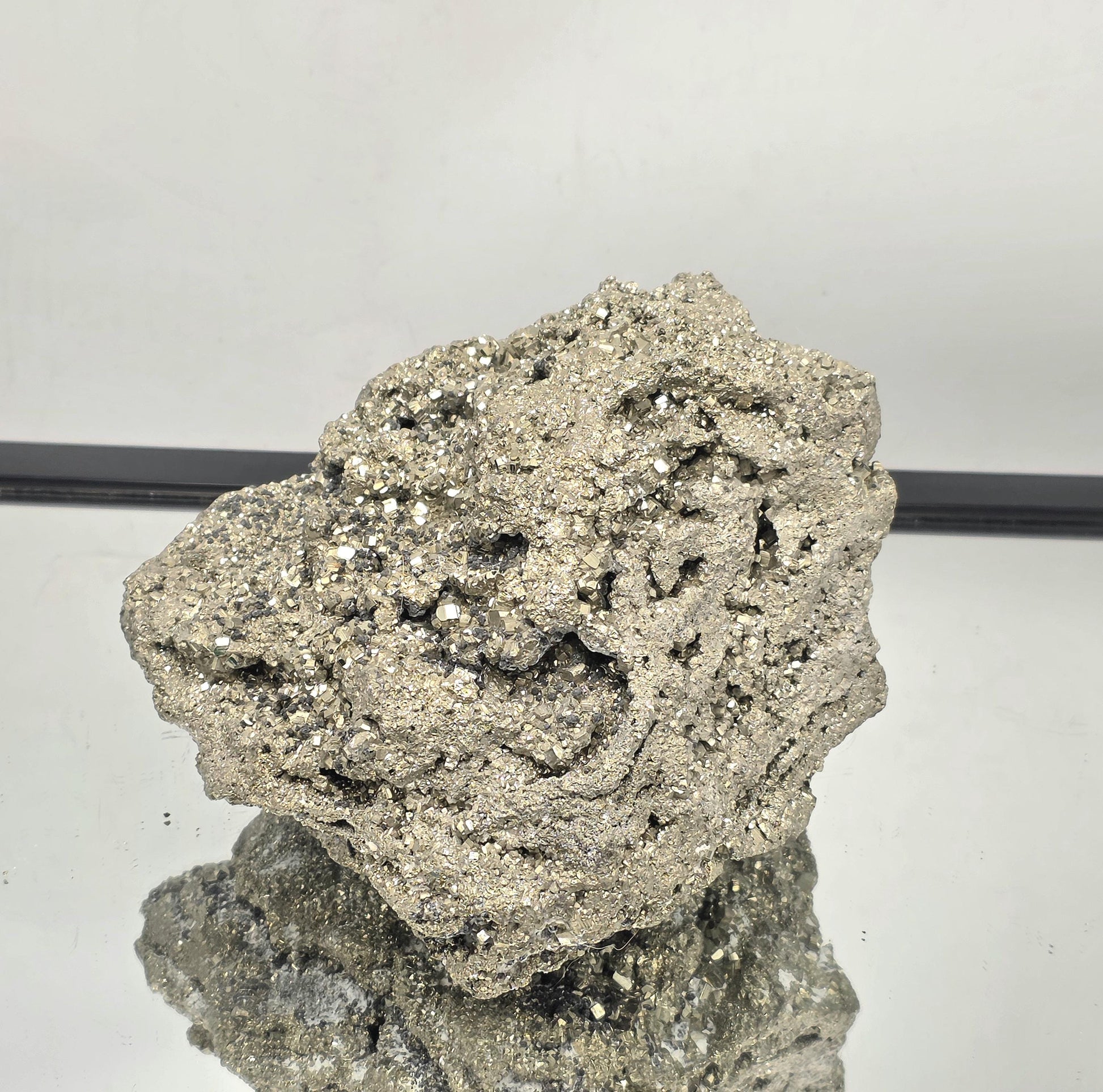 Large natural Pyrite cluster showing metallic golden cubes.