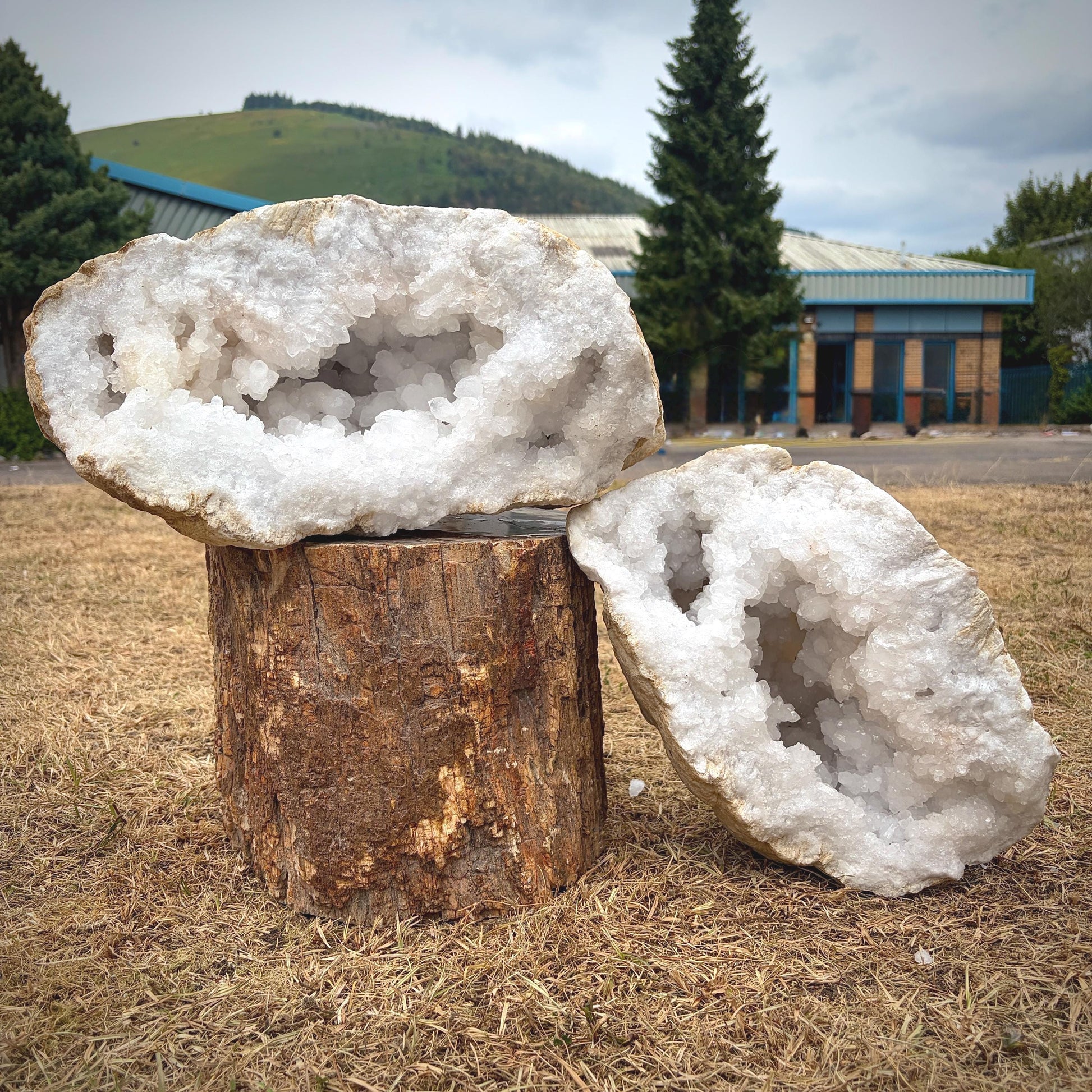 Front view of a large natural quartz crystal geode pair from Morocco with sparkling quartz interiors.