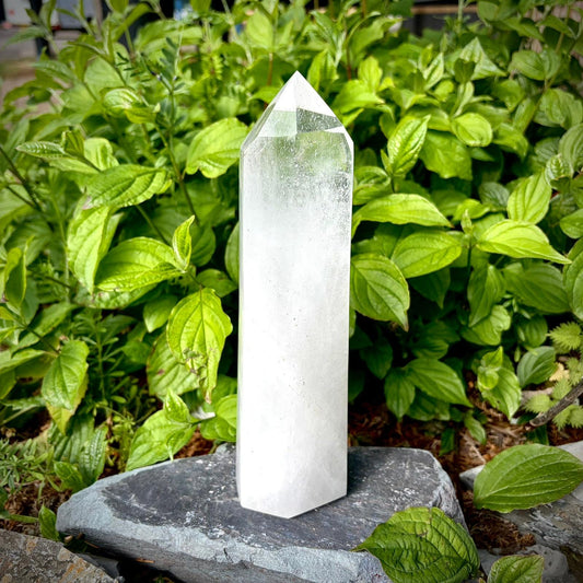 Large polished quartz crystal tower, hand carved in Madagascar, styled as a natural home decor statement piece.