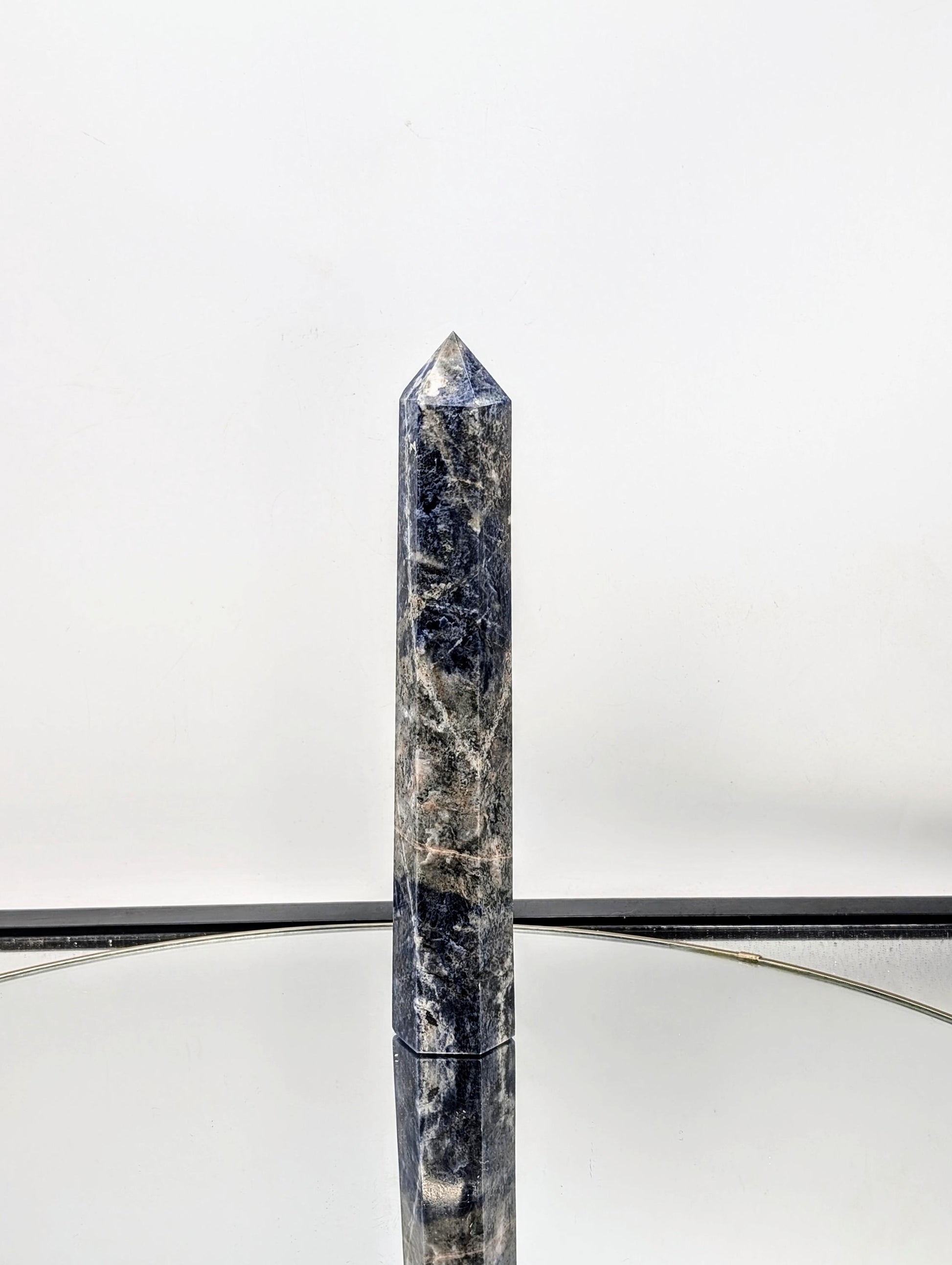 Large Sodalite crystal tower with deep blue hues and natural veins.