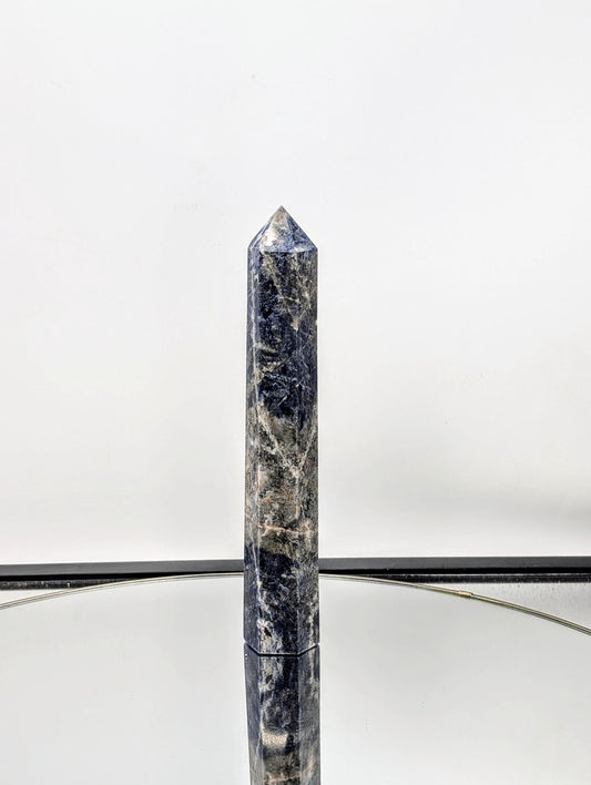 Large Sodalite crystal tower with deep blue hues and natural veins.
