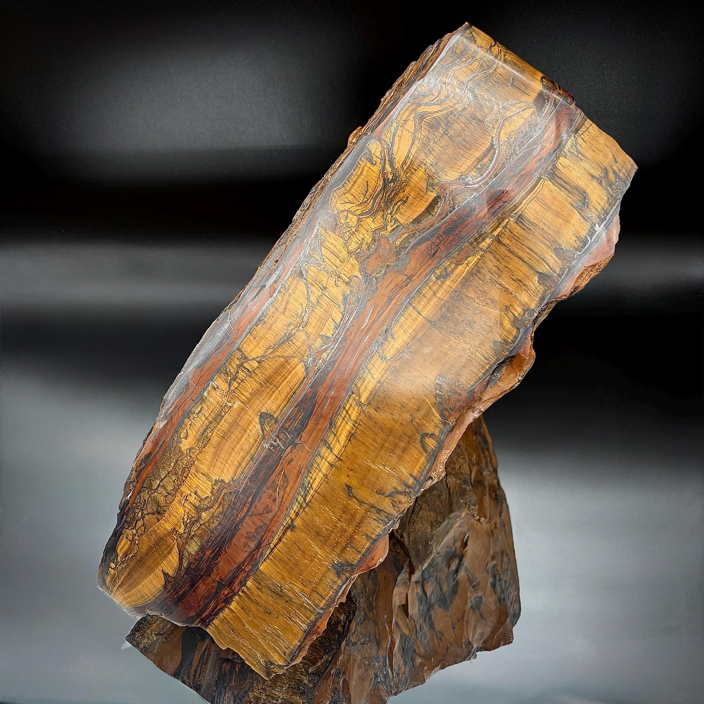 Large natural Tigers Eye mineral specimen with golden brown banding
