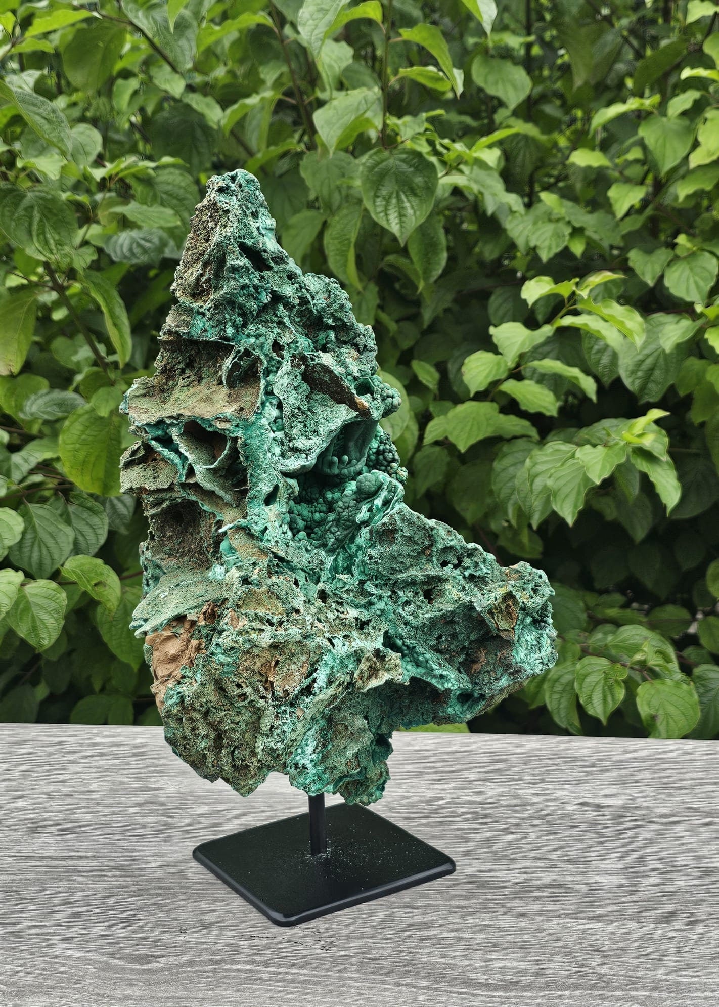 large malachite crystal on custom stand
