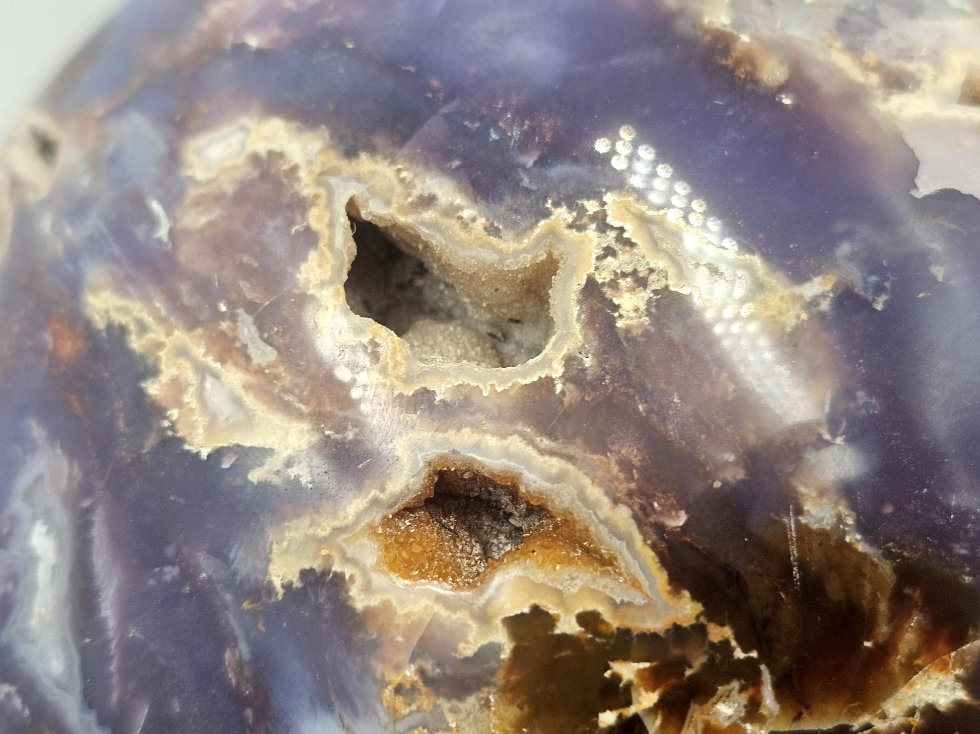 large violet agate sphere with intricate veils and inclusions from Madagascar