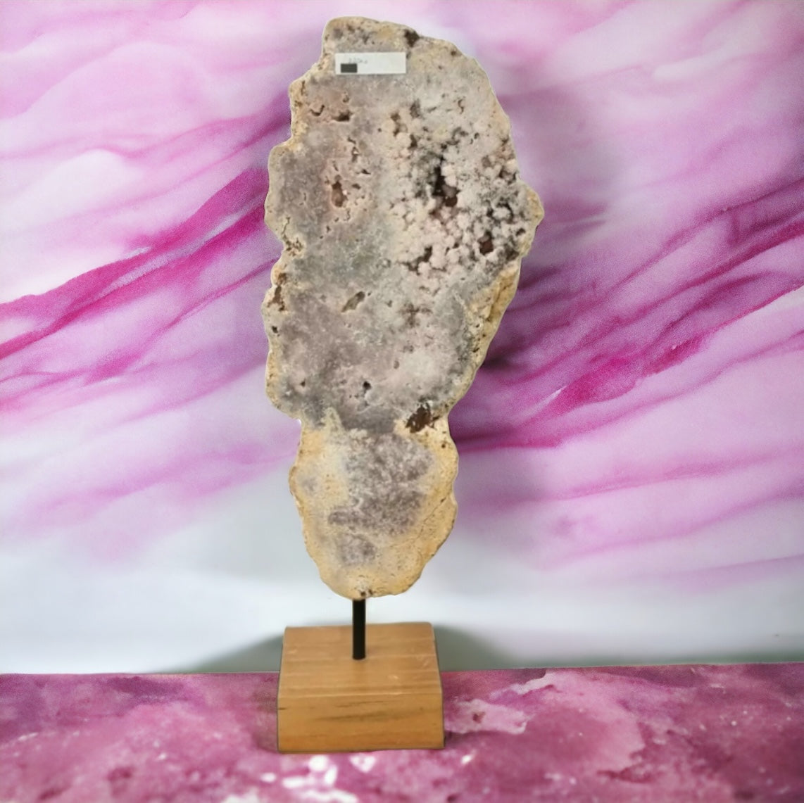 large pink amethyst crystal on stand