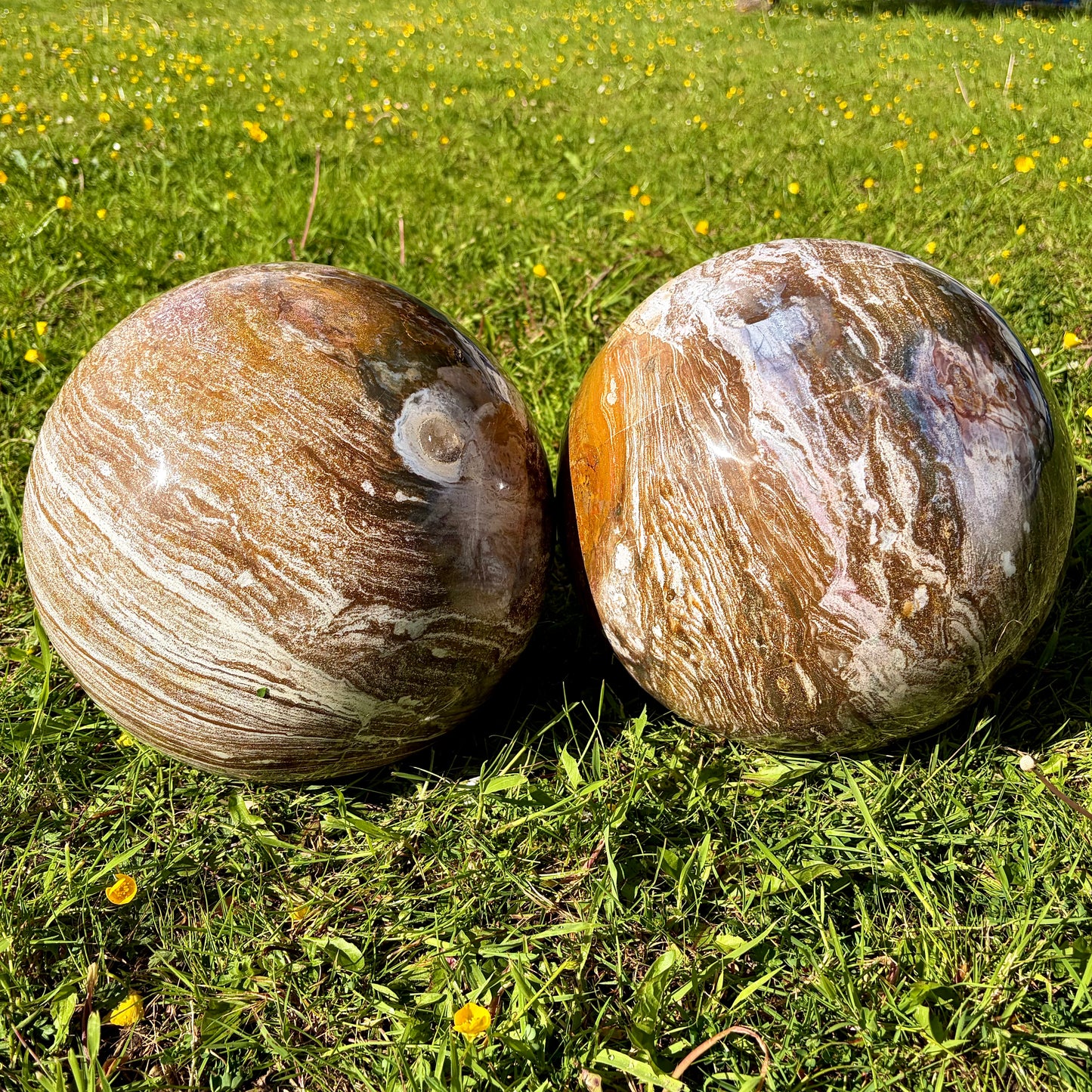 Two large-scale Ocean Jasper spheres with earthy green and crean patterns for home decor.