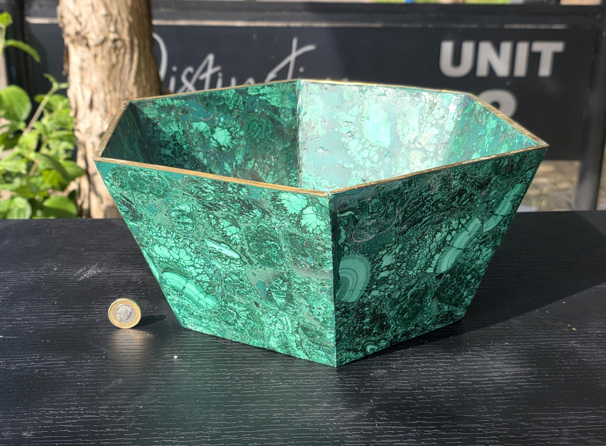 Luxury malachite flower pot highlighting deep green crystal patterns, ideal for upscale home styling.