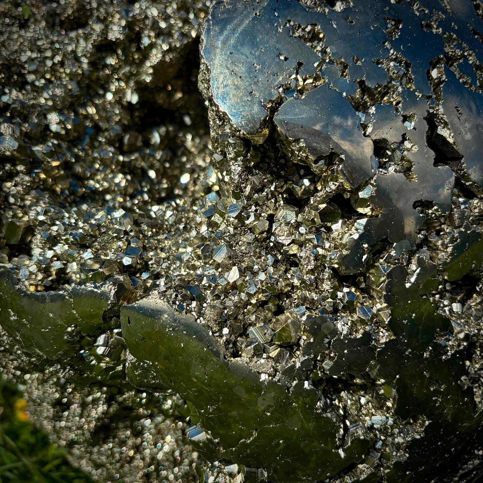 Close-up of natural cubic Pyrite formations on a luxury polished mineral sphere.