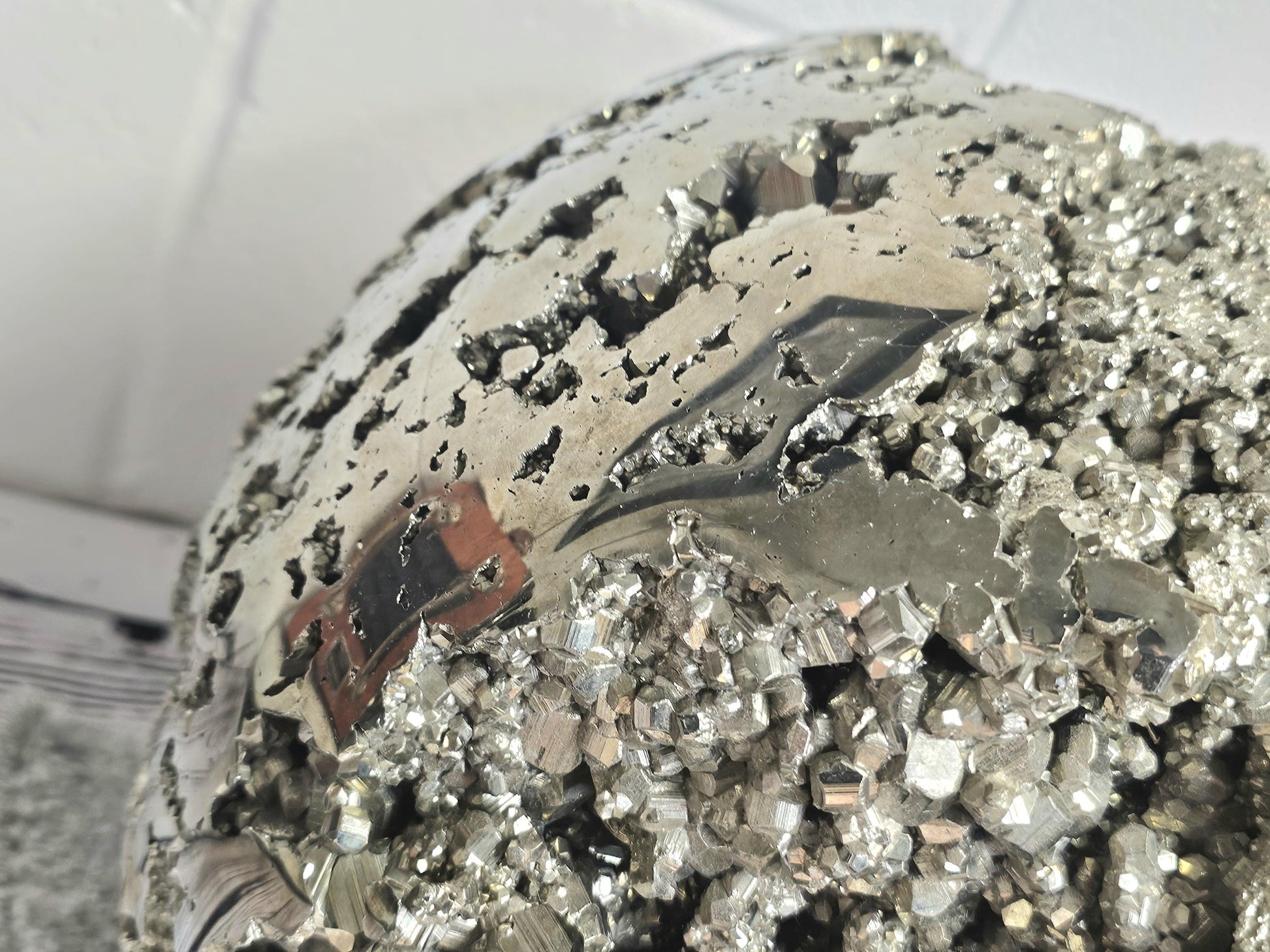 Premium pyrite sphere with sharp cubic crystal structures.