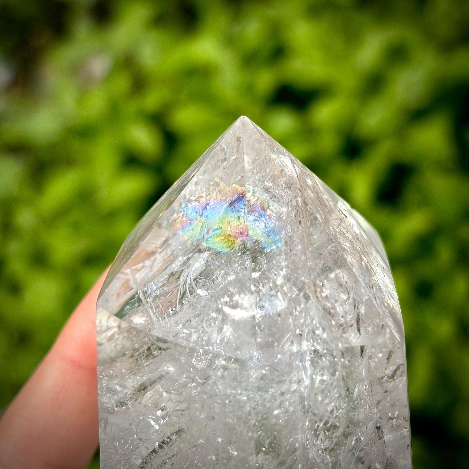 Madagascar clear quartz crystal tower with polished finish and natural internal textures.
