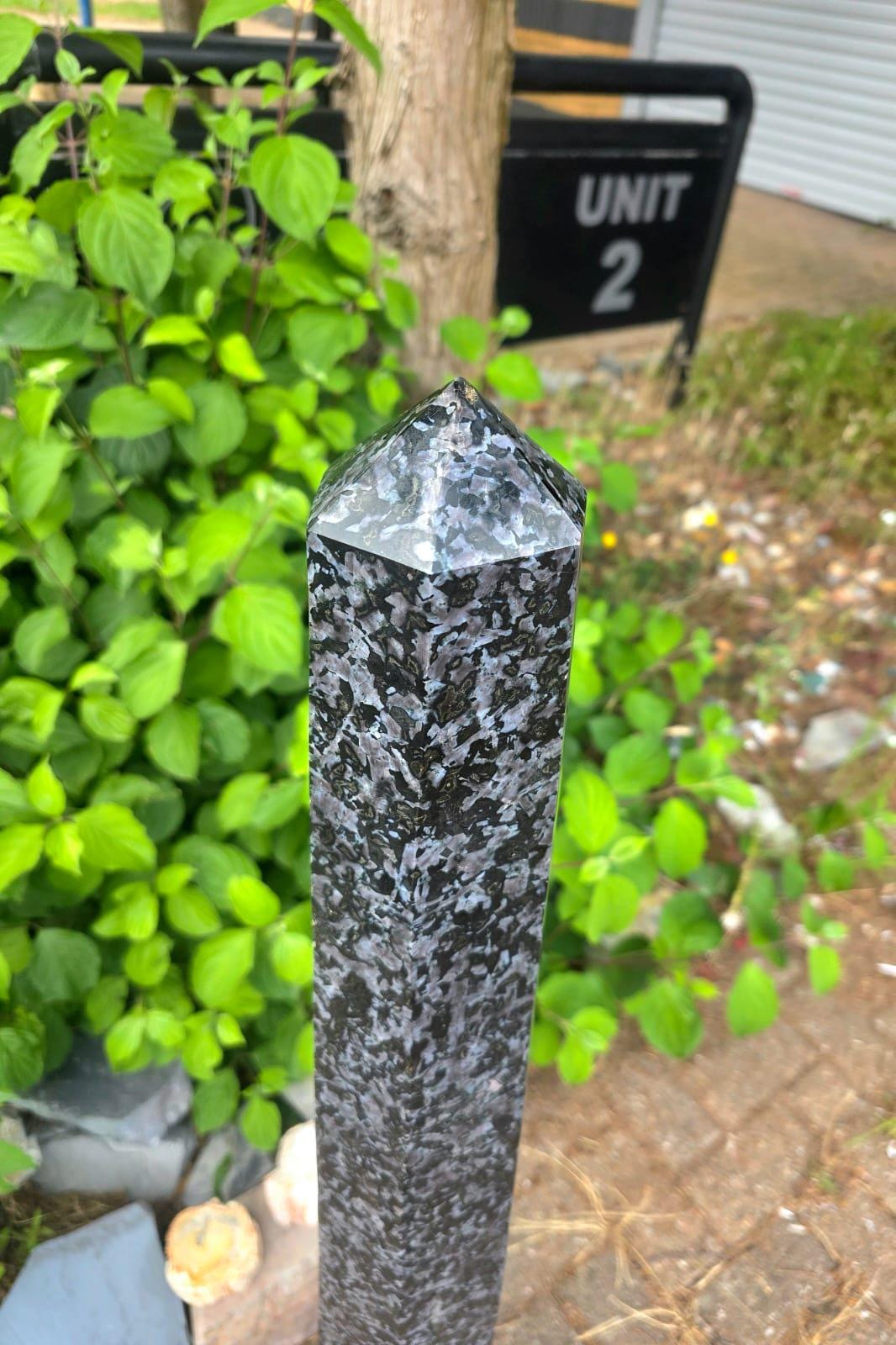Polished pointed top of a tall Madagascan Indigo Gabbro crystal tower.