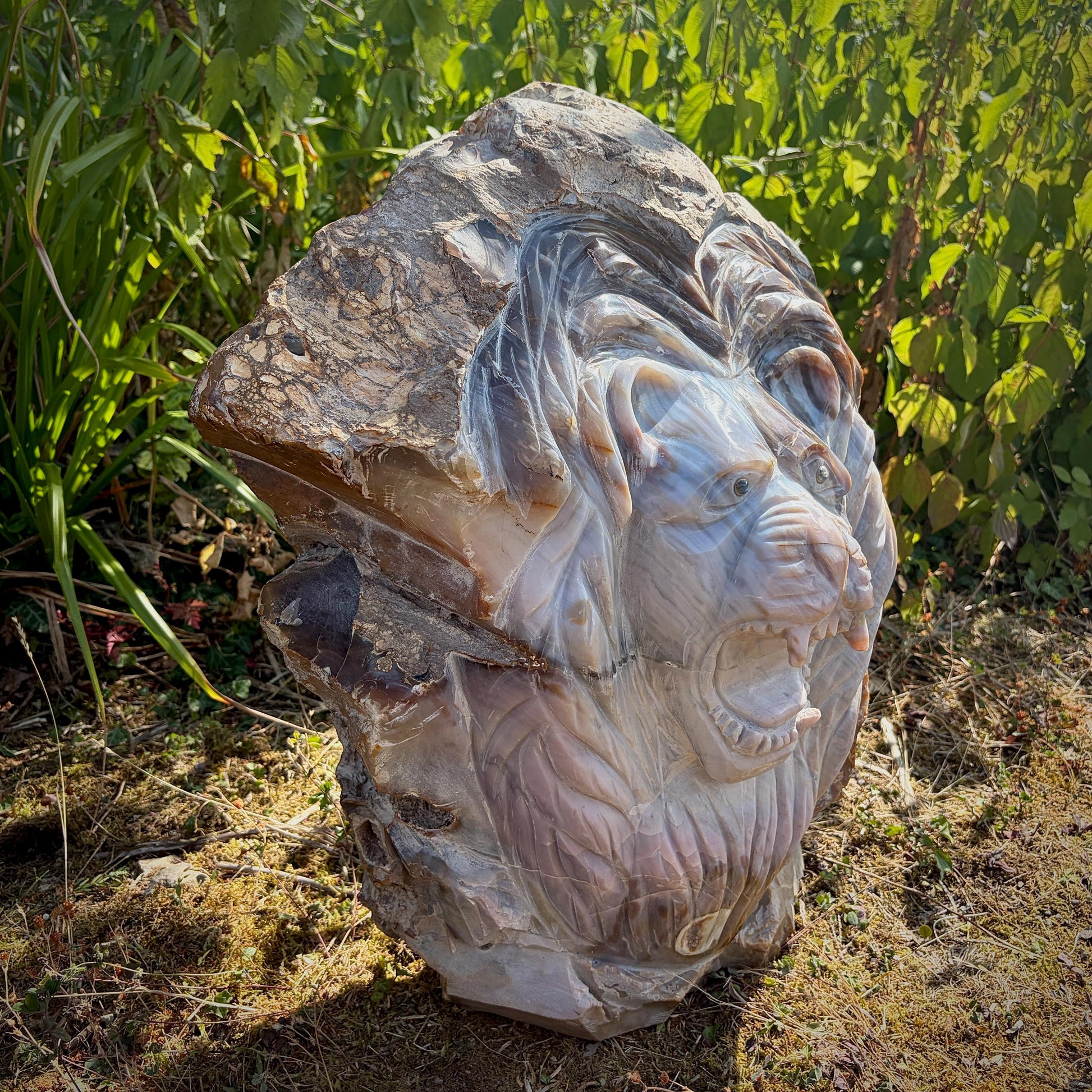 Large Violet Agate lion showcasing intricate carving and natural mineral patterns.