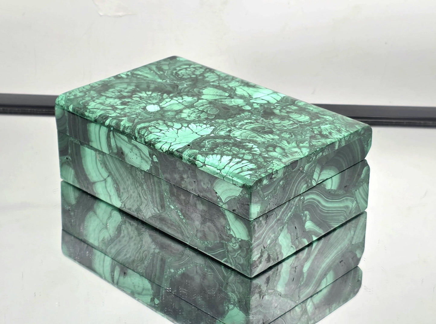 Malachite jewellery box shown open to reveal interior storage
