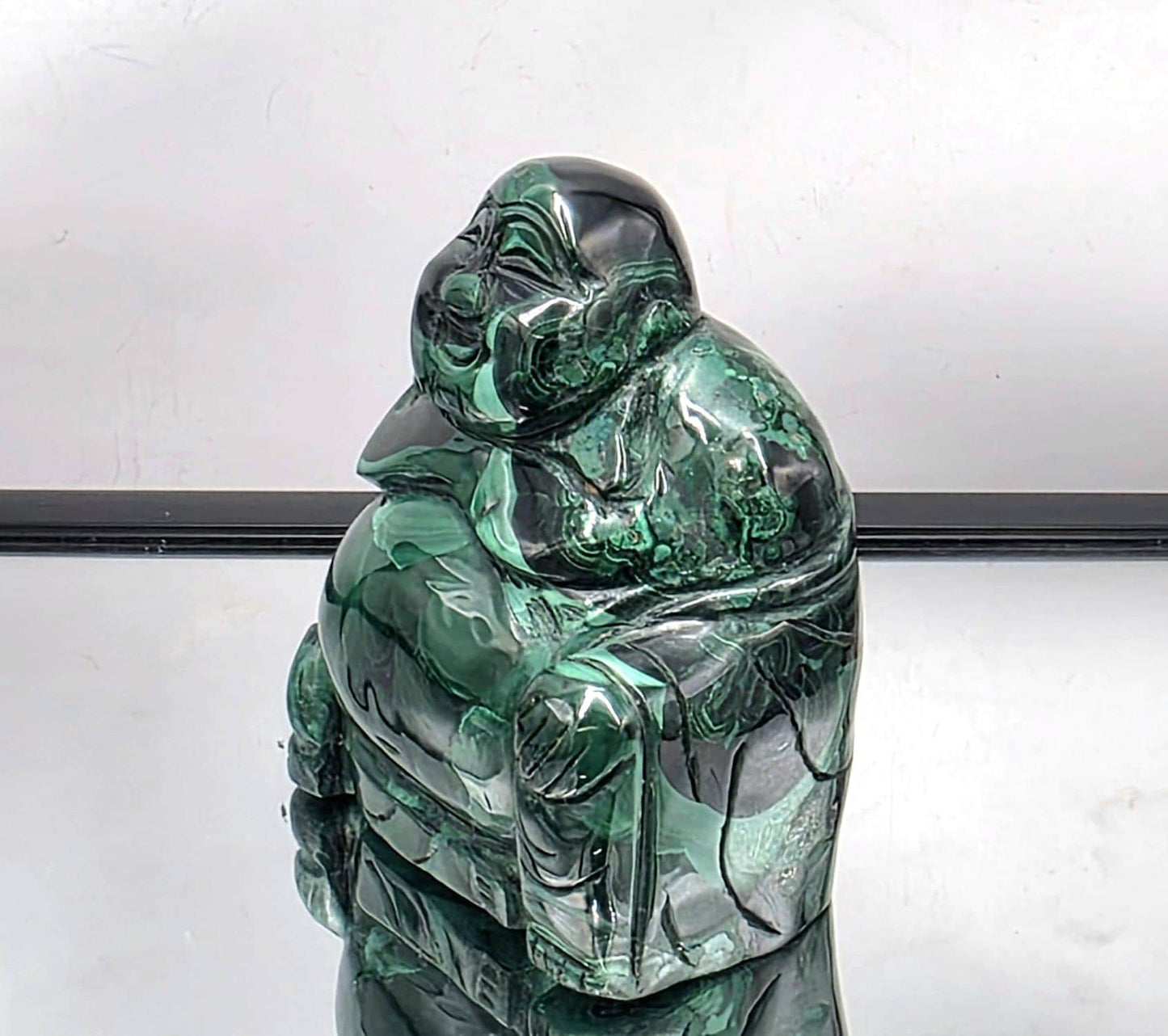 Exquisite Malachite Buddha crystal statue showing swirling green hues and expert craftsmanship, ideal for mindfulness spaces.