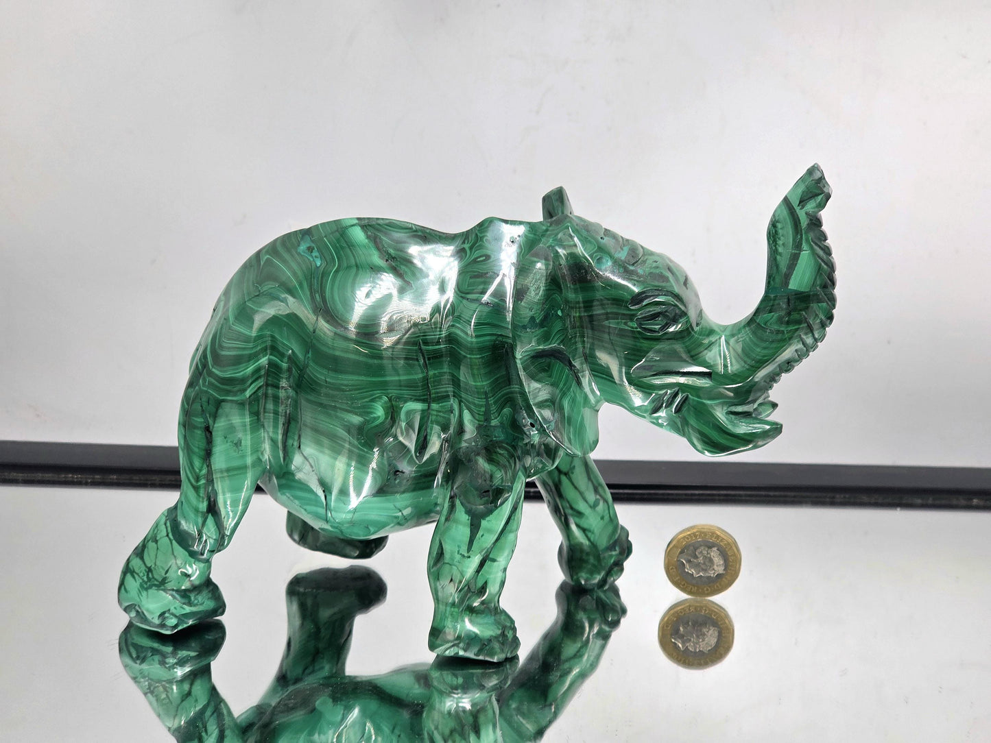 Gemstone malachite elephant sculpture styled in a luxury interior space for elegant natural home décor.