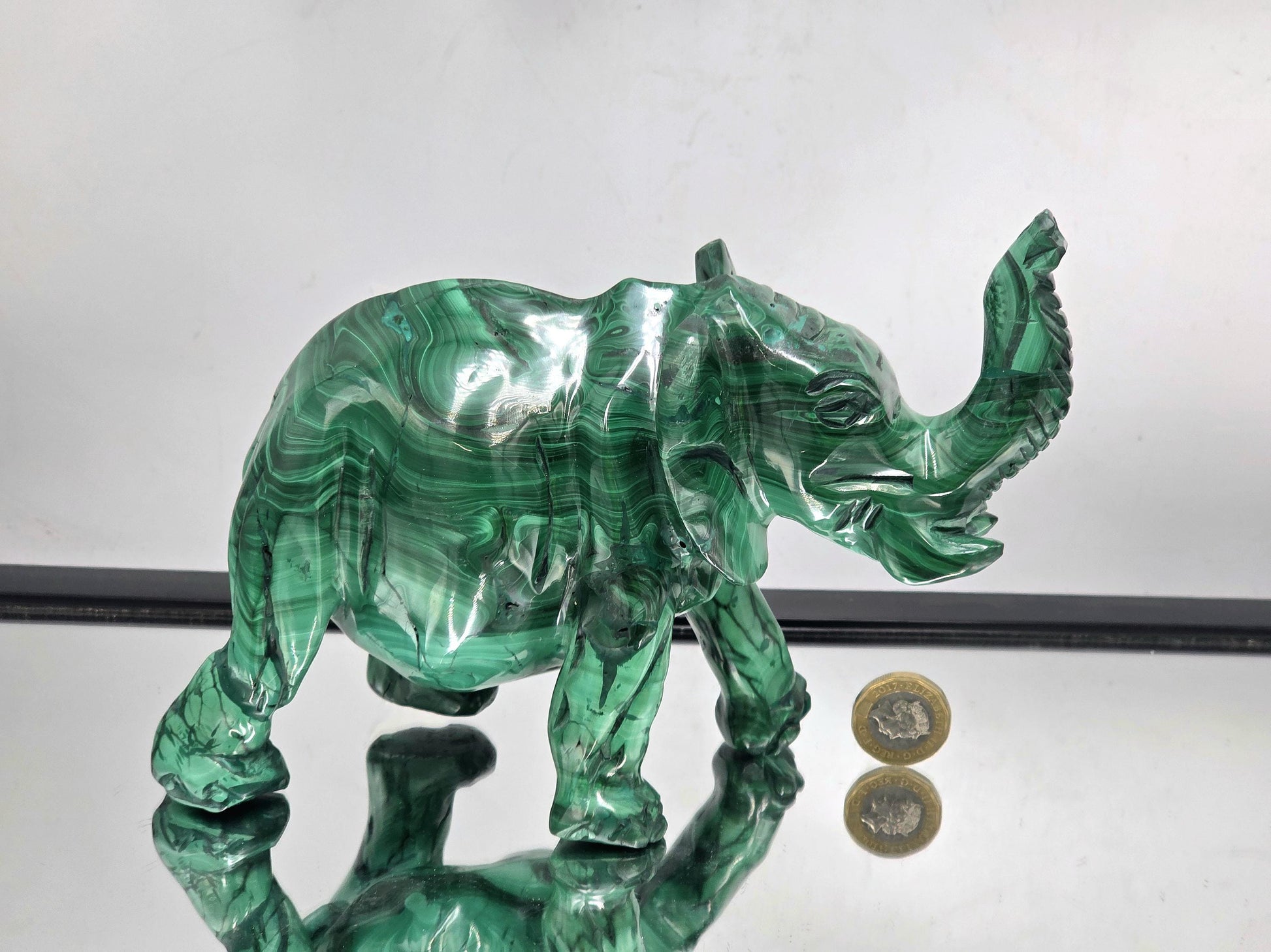 Gemstone malachite elephant sculpture styled in a luxury interior space for elegant natural home décor.