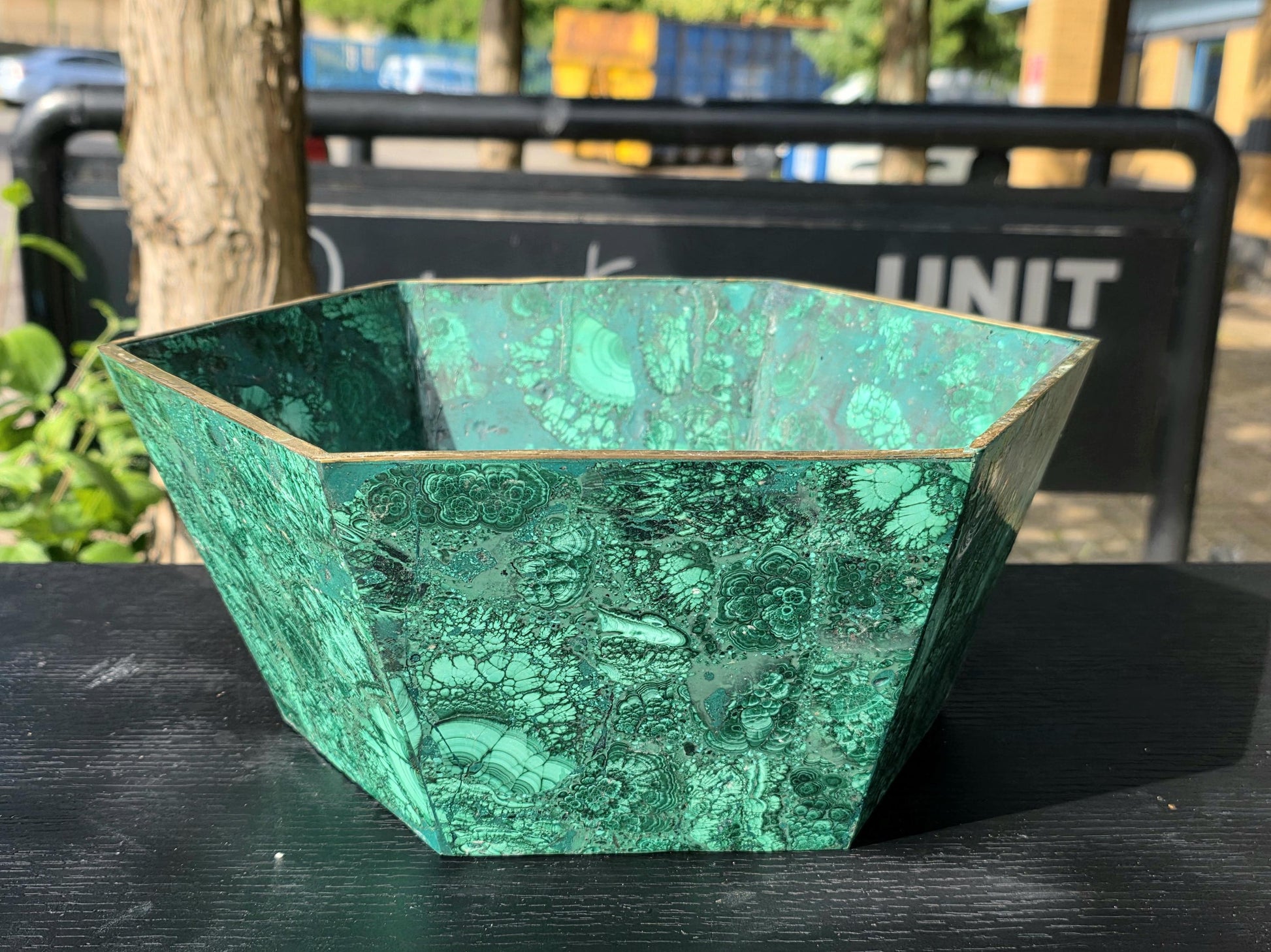 Handcrafted malachite flower pot showcasing natural crystal slices, perfect for sophisticated interior décor.