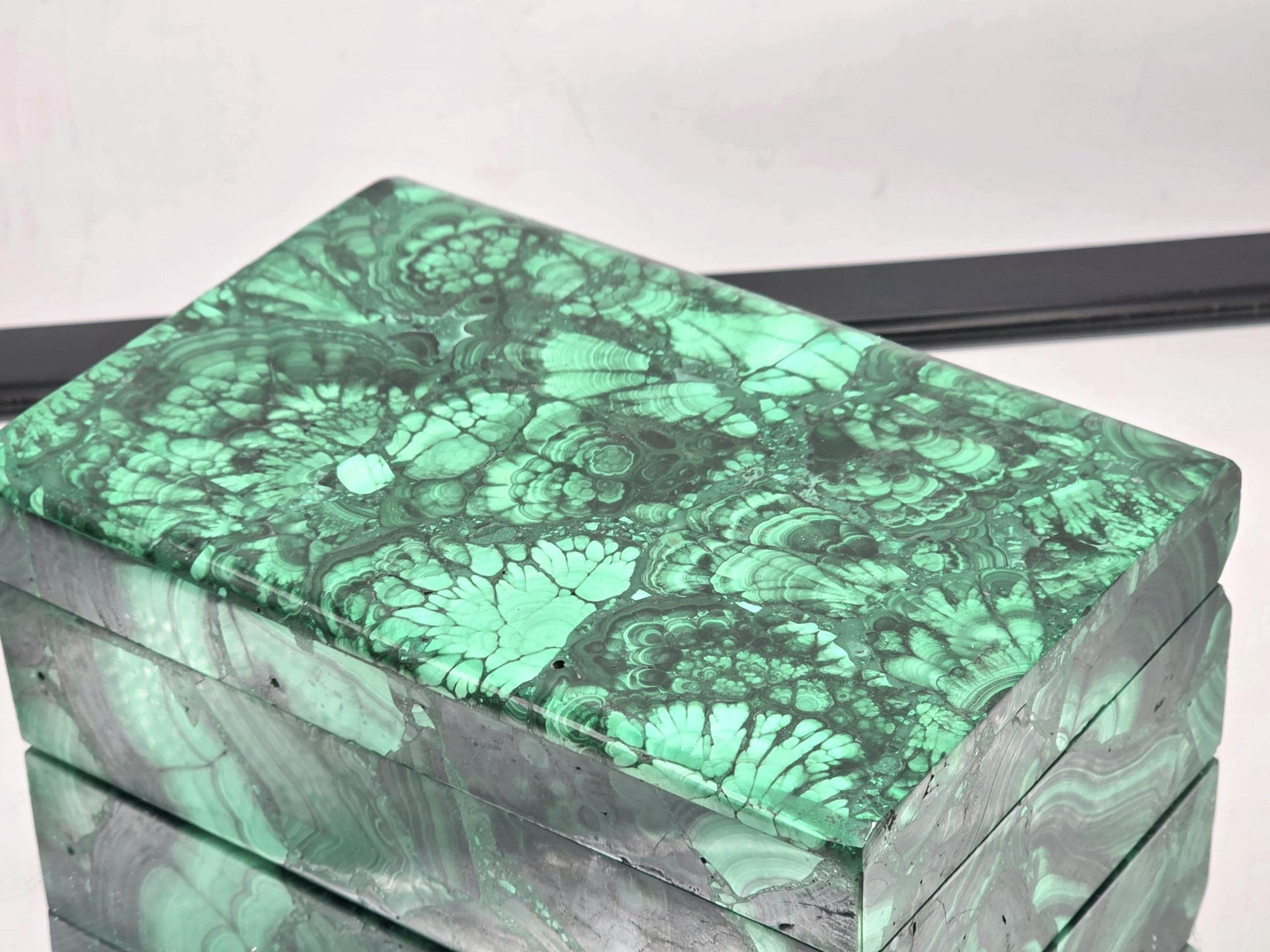 Close-up of Malachite gemstone box highlighting banding and polish
